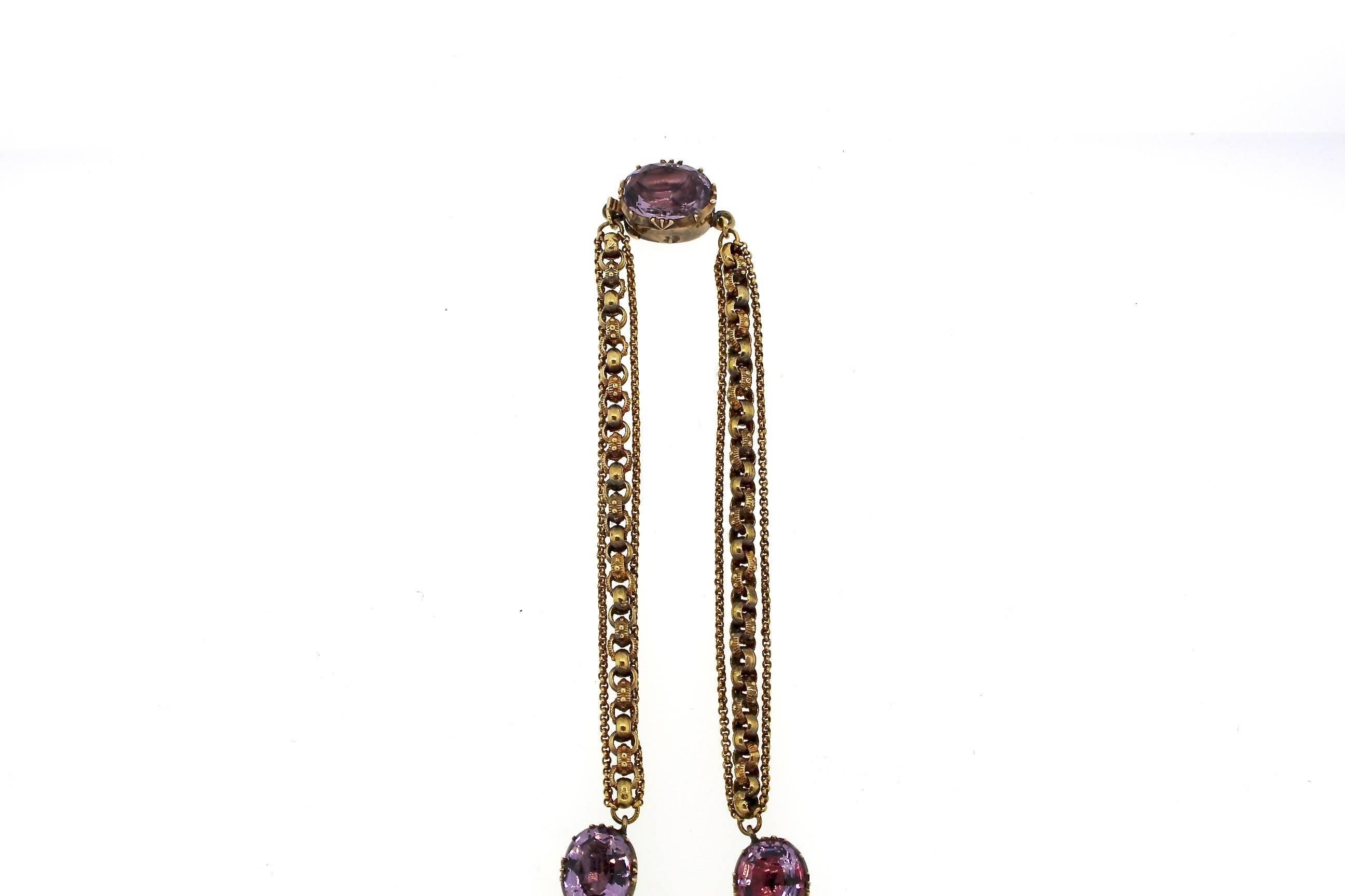 An early Victorian foiled back amethyst maltese cross pin and pendant suspended from a unique chain necklace accented by collet set foiled oval amethysts.  The necklace is 14k gold, and likely made in America around 1850.  The necklace is delicate. 