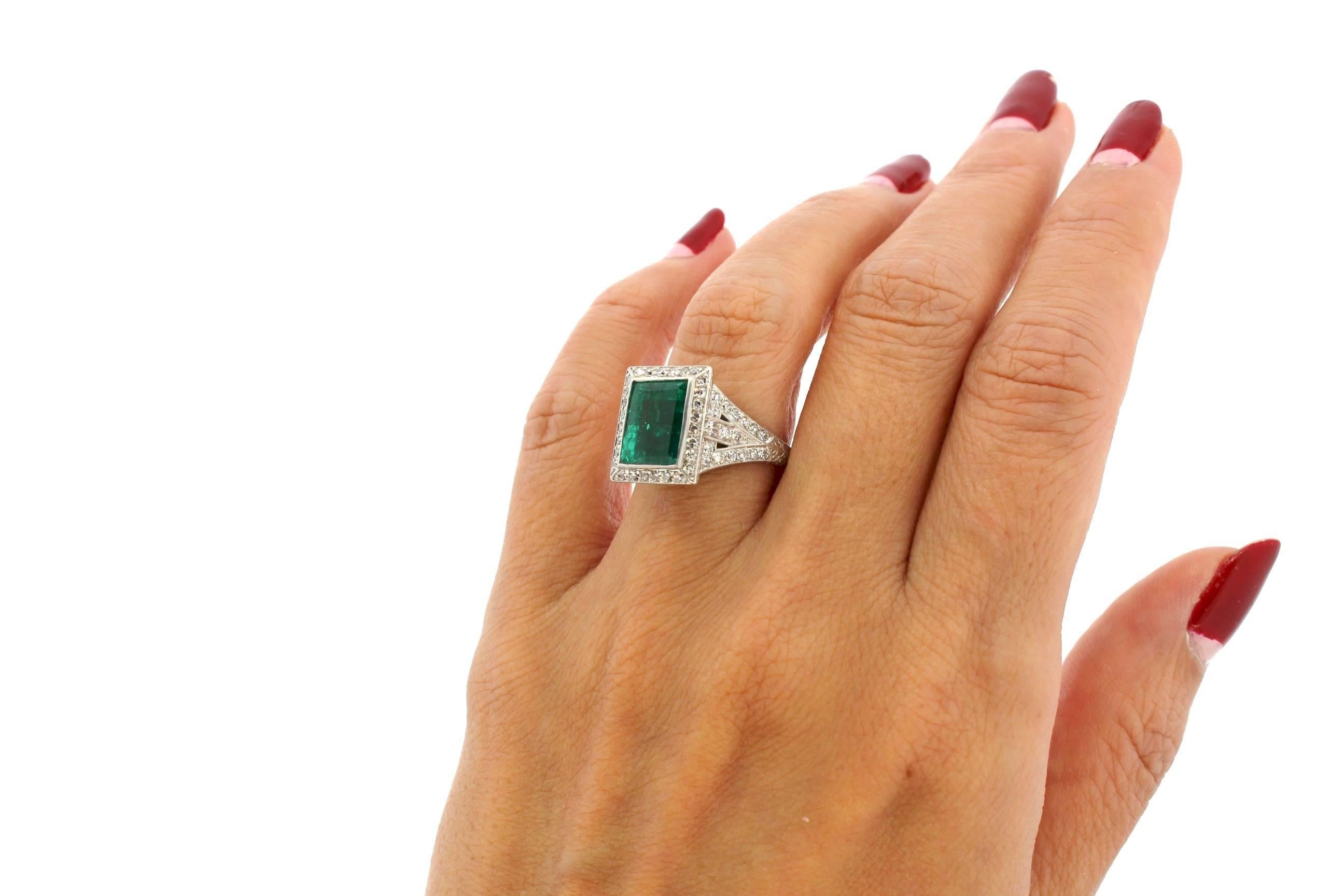 This is a beautiful emerald cut fine Emerald ring set in a handmade Art Deco platinum setting.  The emerald is measured to be about 4 carats, and is accompanied by a certificate from the American Gemological Laboratories stating that it is from