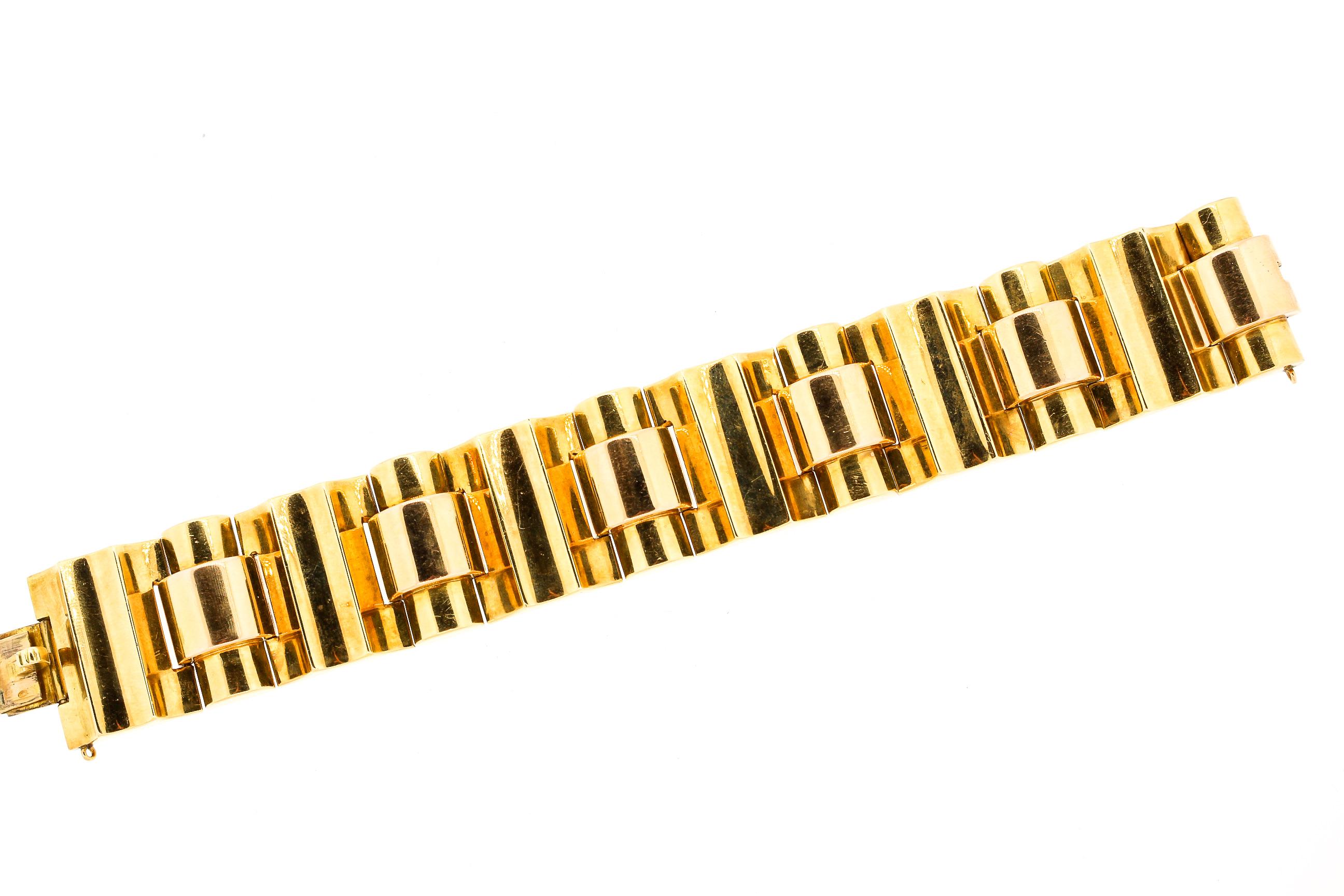 A bold wide 18k gold modernist Retro two tone bracelet. This bracelet has considerable heft and feels luxurious to wear. The bracelet link is slightly contrasted between yellow and rose gold. This is a classic Retro Tank bracelet. During World War