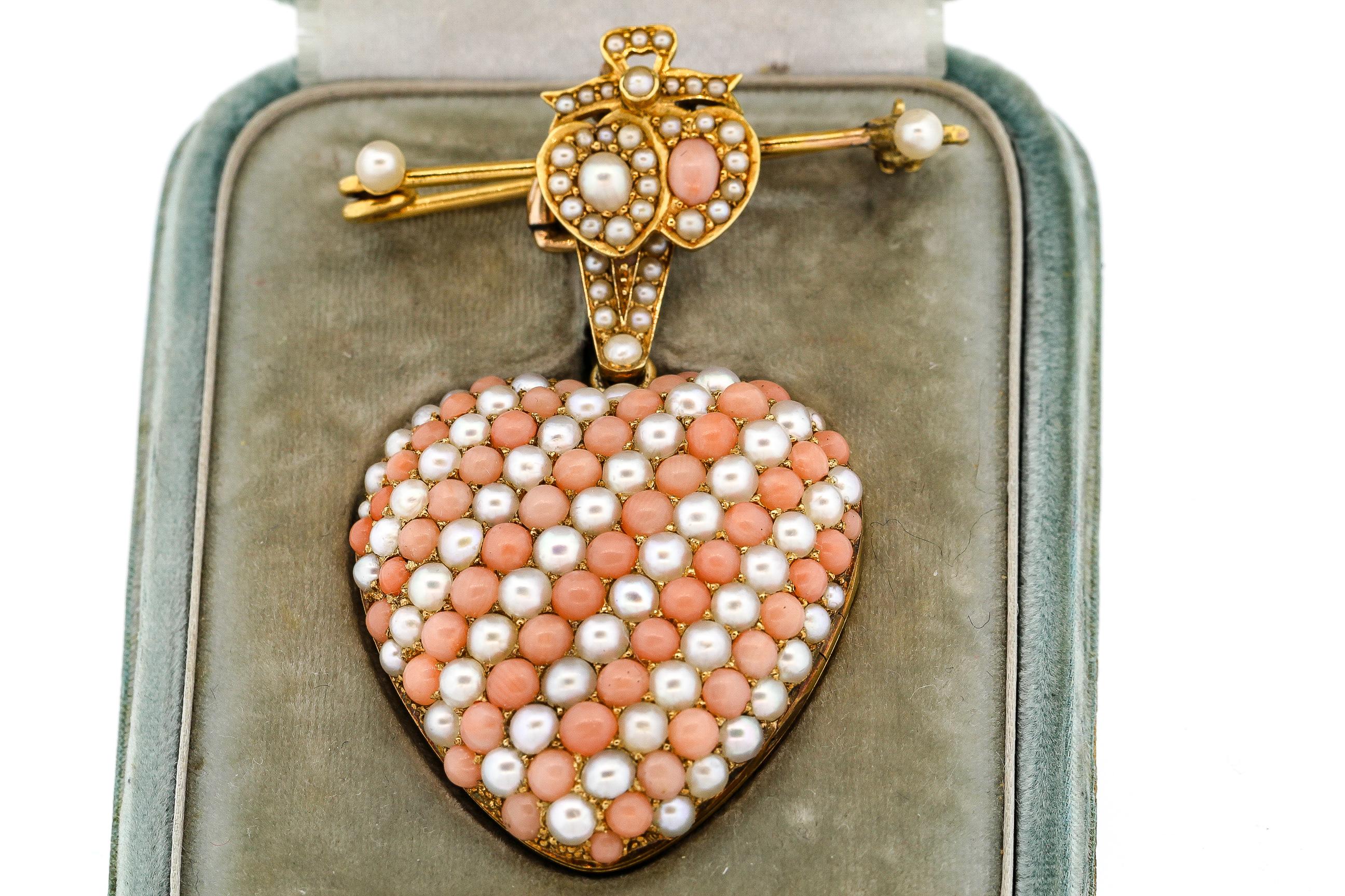 Antique Victorian heart locket studded with pearls and coral with pin attachment and fitted box, circa 1860. This large and impressive coral pendant opens to reveal a locket that could hold ribbon, hair or a photo. The locket has a nice size bail