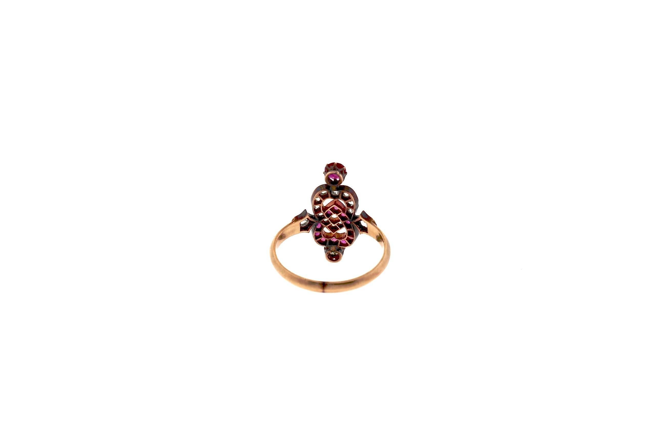 Sweet and sentimental and quintessentially Victorian. A rose cut diamond heart interlocks with a ruby heart in a vertical design. The ring is made in 18k gold and topped in silver where the stones are set. This was a Victorian way of making jewelry