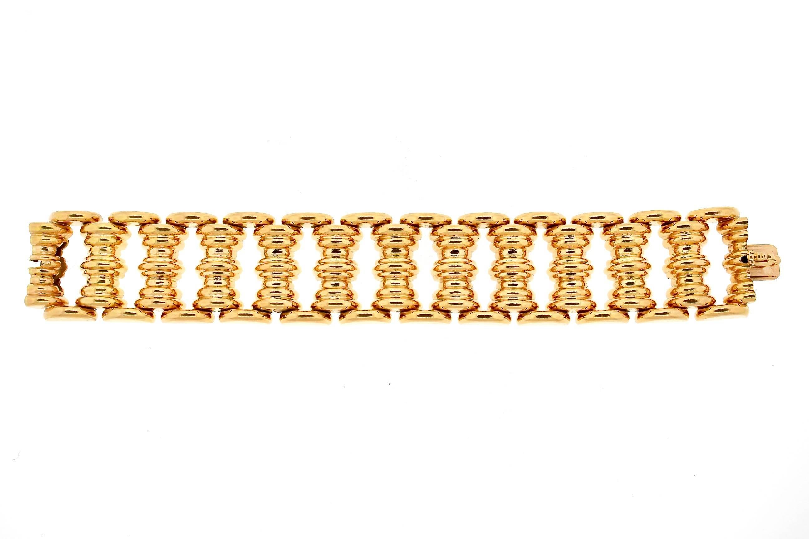 A bold gold bracelet is often a staple in a woman's jewelry collection.  Its sturdy enough to be worn everyday during the day, and yet stylish for all fashions.  This 18k yellow gold Retro tank style bracelet has a polished and elegant link. 