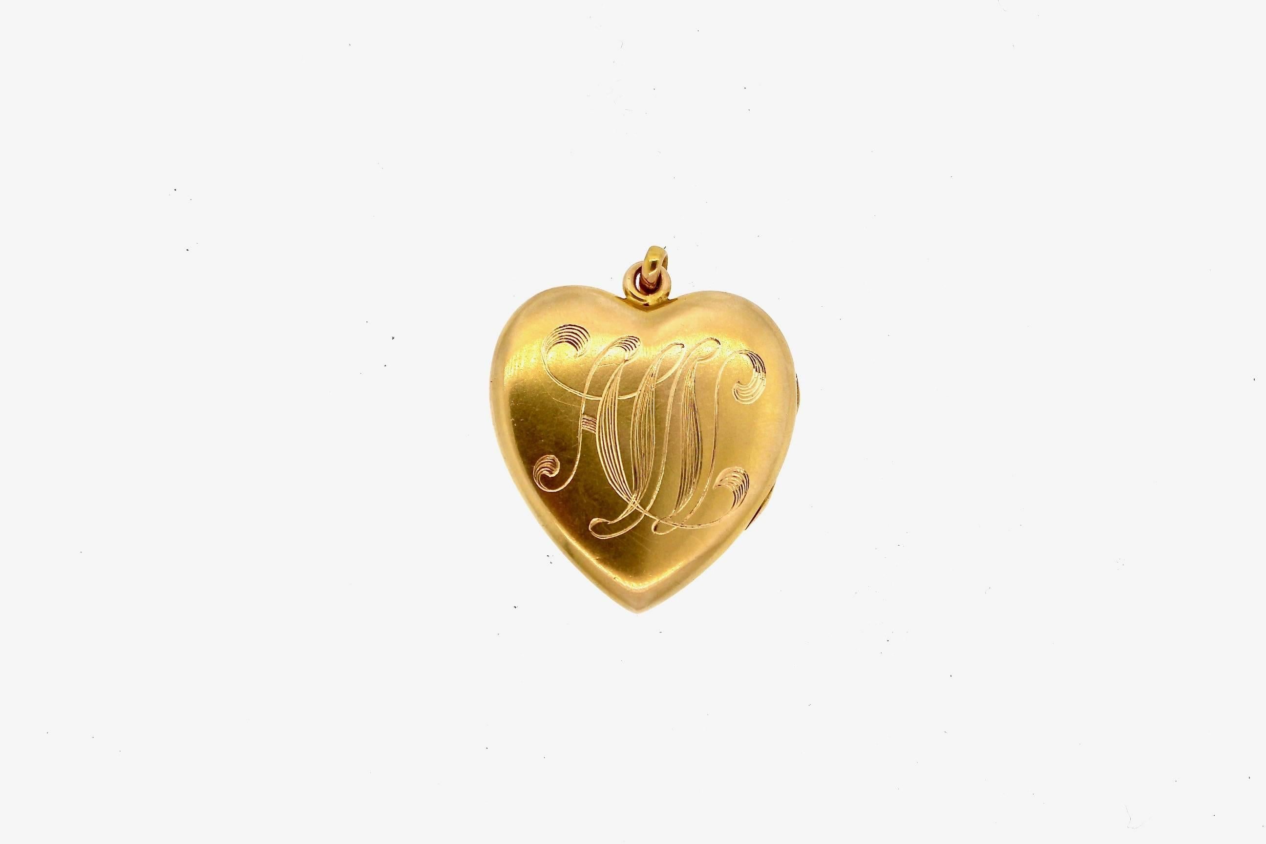 Lockets throughout history have held memories of those held dearest.  Whether hair, or photographs a locket holds cherished items. This gold locket in the shape of a heart has the original photographs.  Made in 14k yellow gold, it is a beautifully