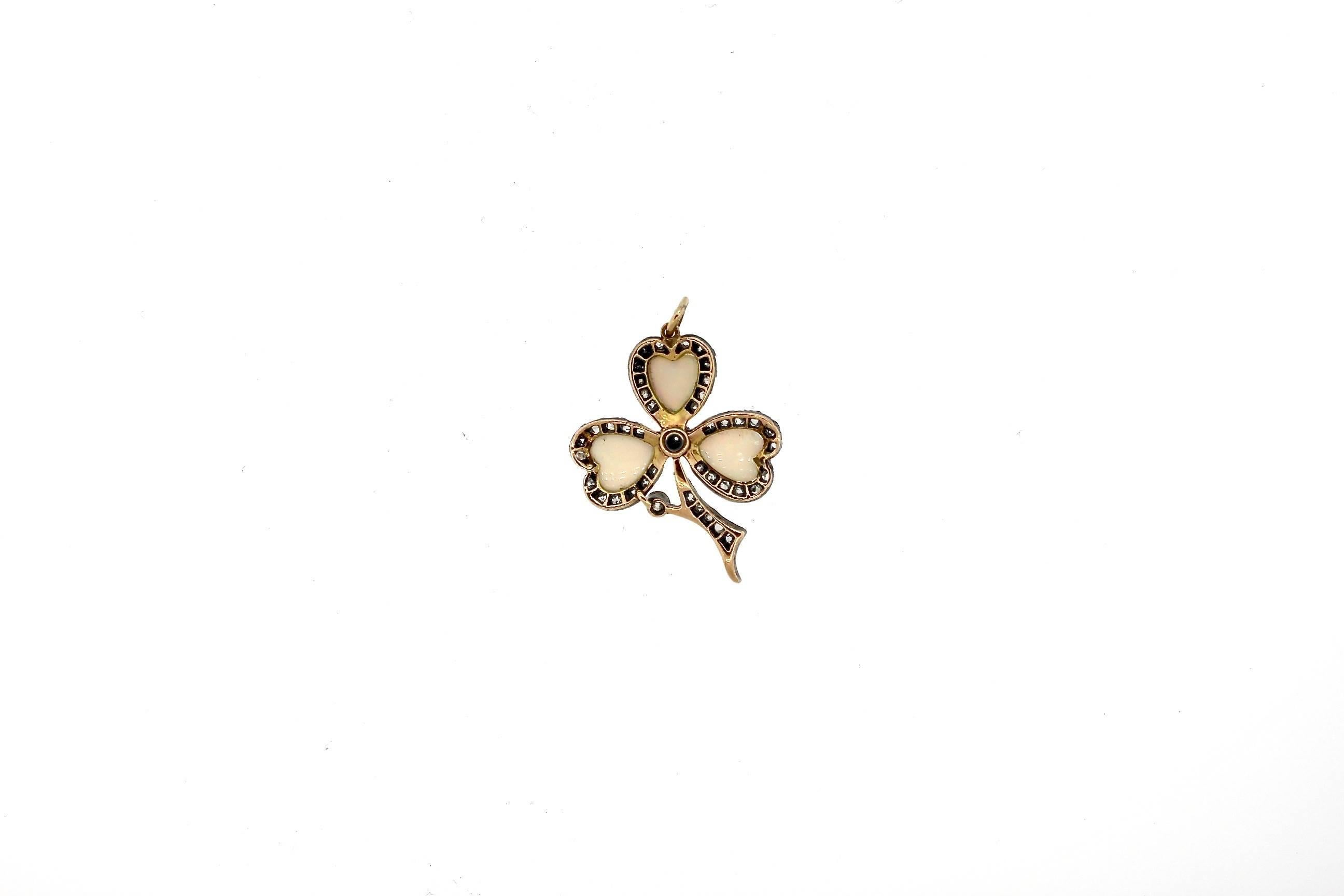 A pretty silver-topped gold diamond and opal clover pendant circa 1890.  This sweet pendant is set with heart shape white opals with red flashes.  The opals are surrounded by 42 old cut diamonds weighing about 0.40 cts total.  the pendant is about