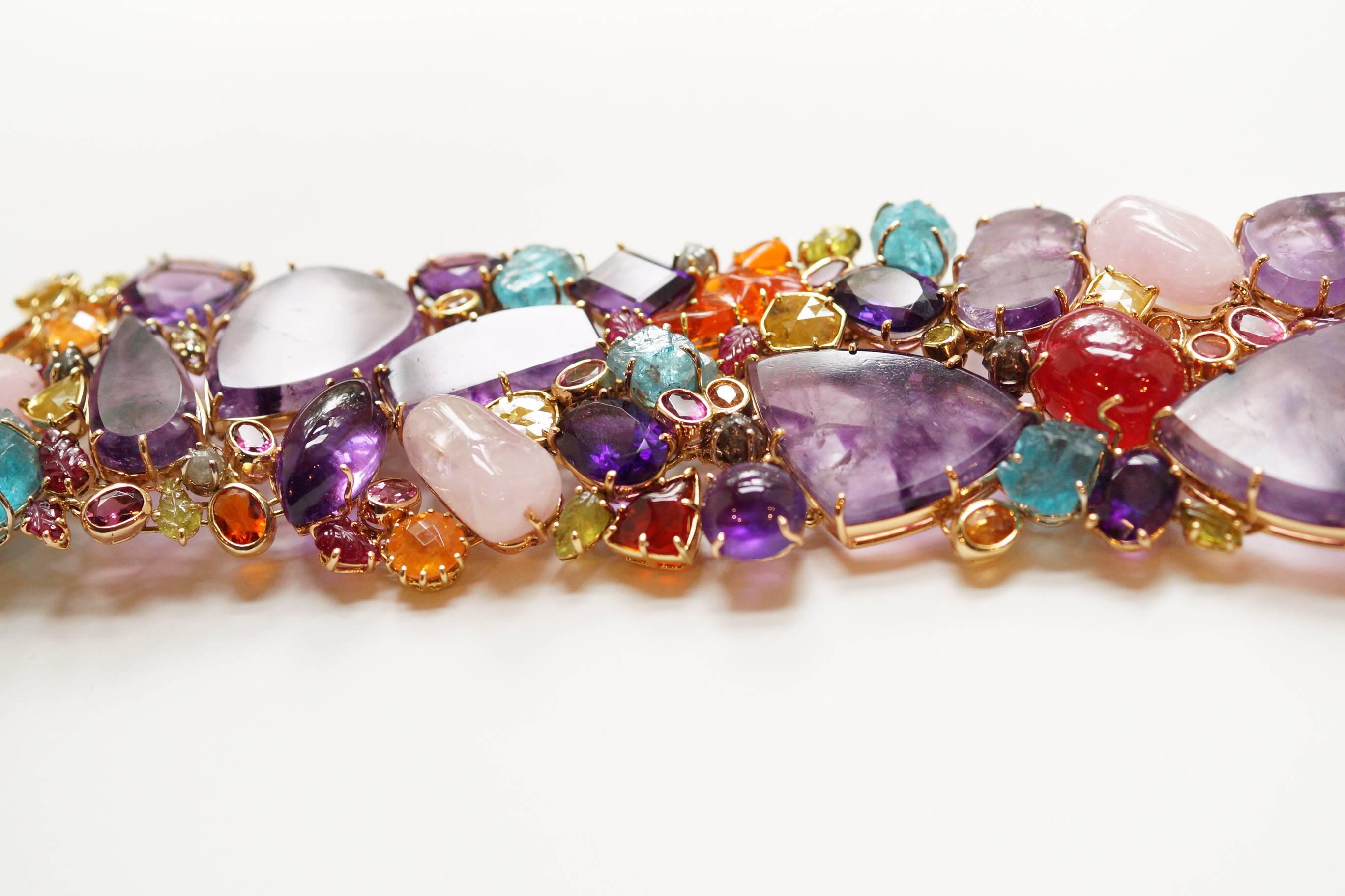 Pandora Bracelet
A large bracelet composed of a mélange of natural gemstones and diamonds, living side-by-side in chaotic harmony.  The largest gems in this piece, which define the structure, are flat slices of natural amethyst.  They have been