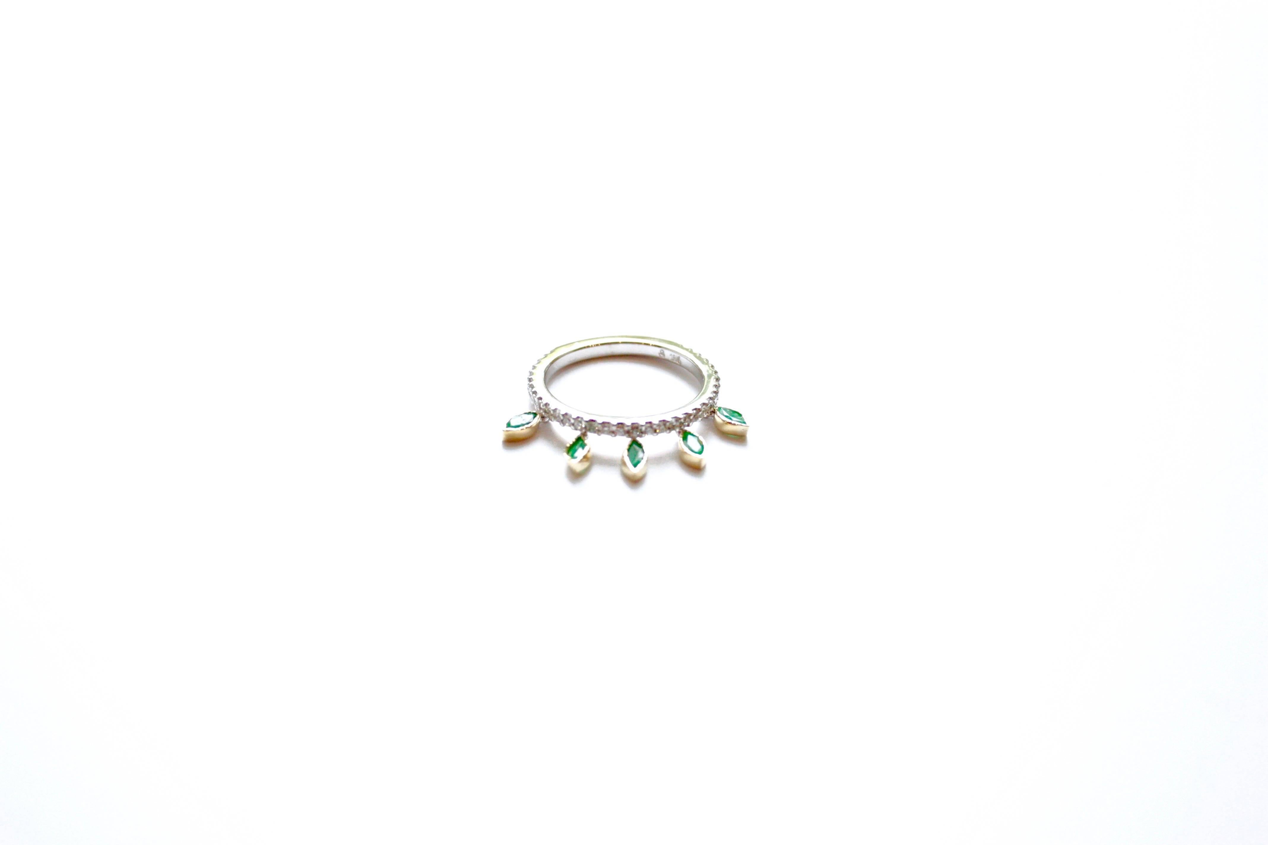 Shimmee® Ring
An eighteen-karat white and yellow gold ring set ¾ of the way with white diamonds.  Suspended unpredictably off one side of the ring are five flexible marquise faceted emeralds.  This modest movement adds discreet glitter to the