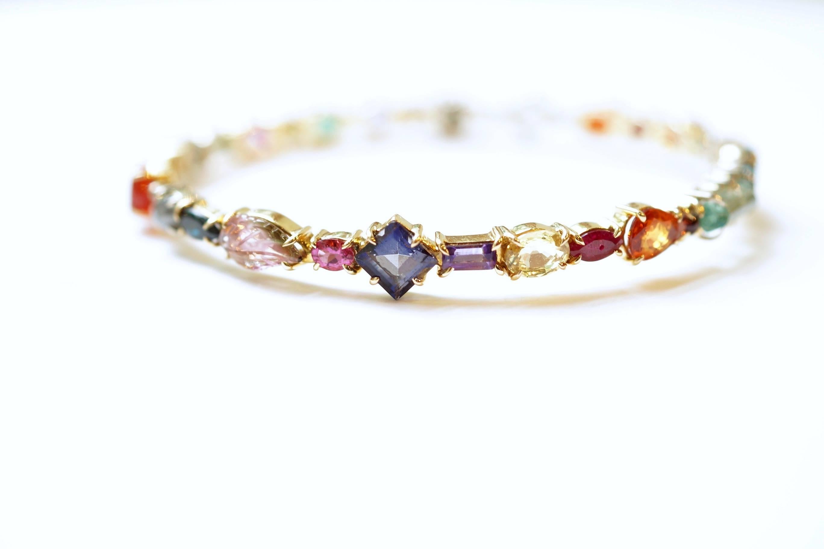 Baby Bangle
An eighteen-karat yellow, rose, and white gold bangle composed of different shades, colours and cuts of natural gemstones and diamonds. 
2 ½ diameter
Diamond Total Weight – 2.91 cts.
Gemstone Total Weight – 15.21 cts.
Coloured