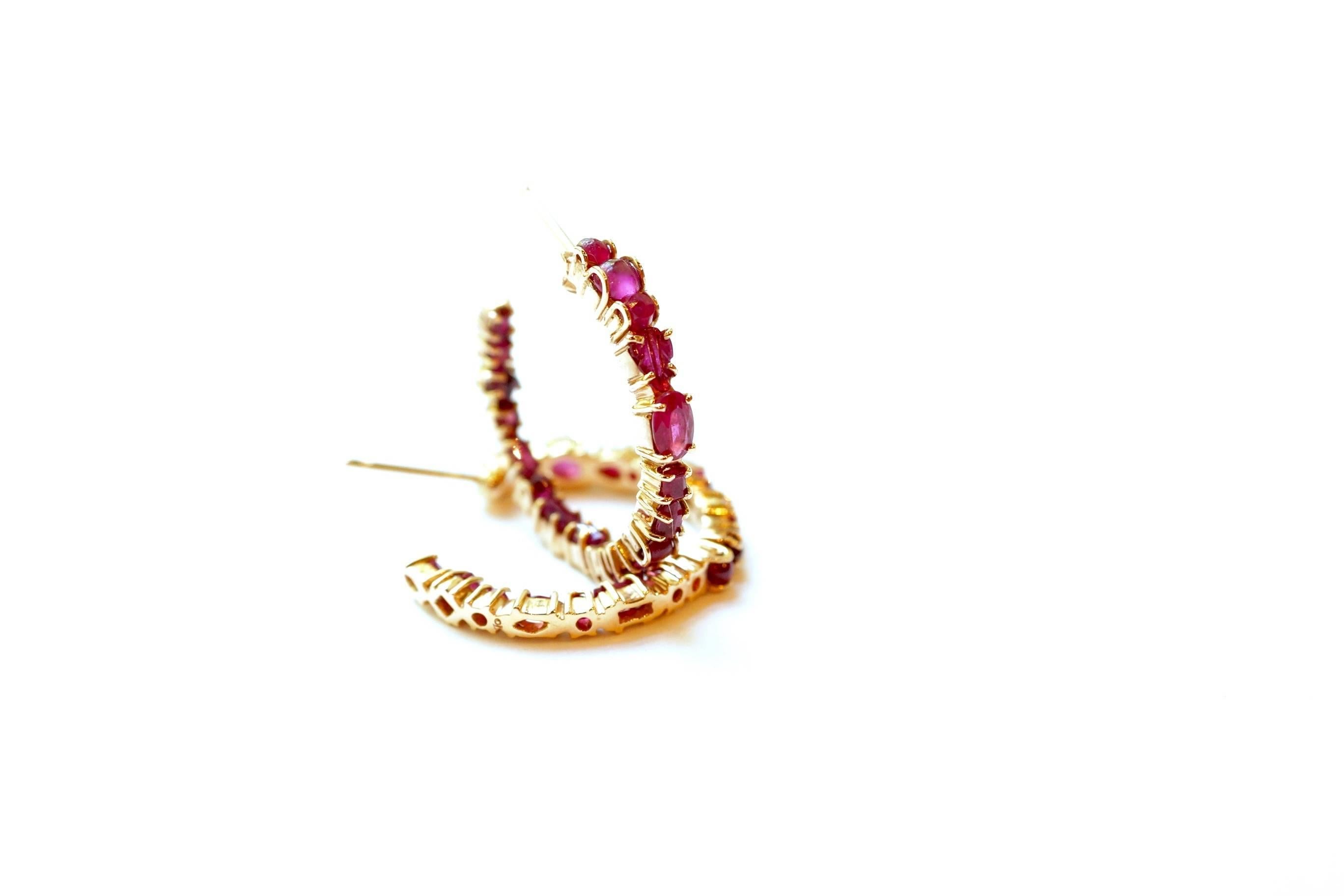 Baby Hoop Earrings
A pair of eighteen-karat rose gold hoop earrings set with a mélange of different shades and cuts of rubies.
Gemstone Total Weight – 3.67 cts.
1-inch diameter
This piece, in its entirety, has been created and handcrafted in New