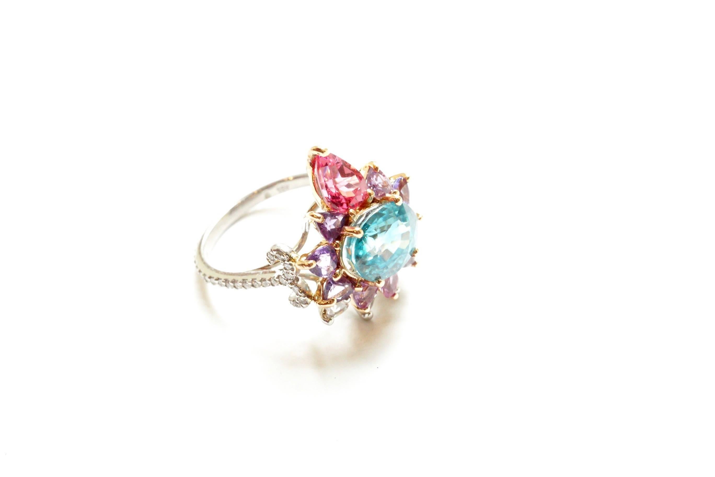 Arnez Ring
A 3.84 carat ovular blue zircon, set with an entourage of pink and purple sapphire trillions and one large pear-shaped Tanzanian spinel.  Around this surround is a smaller group of pear-shape rose-cut diamonds.  The shank has been