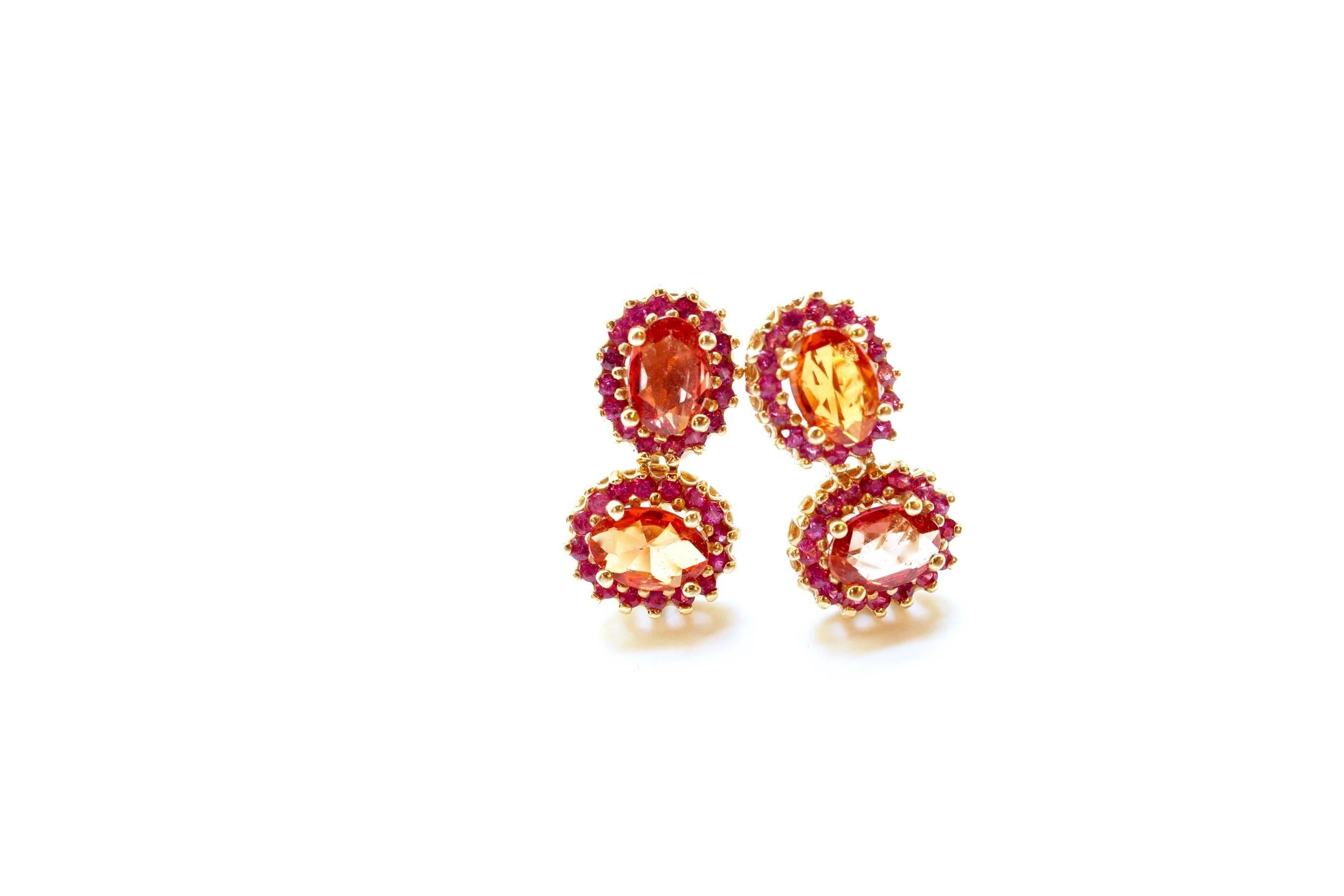 Larra Eardrops
A pair of eighteen-karat pink gold detachable earpendants, composed of three motifs.  The two top motifs, oval faceted orange sapphires, have been surrounded with smaller pink sapphires.  Dropping directly below is a single organic