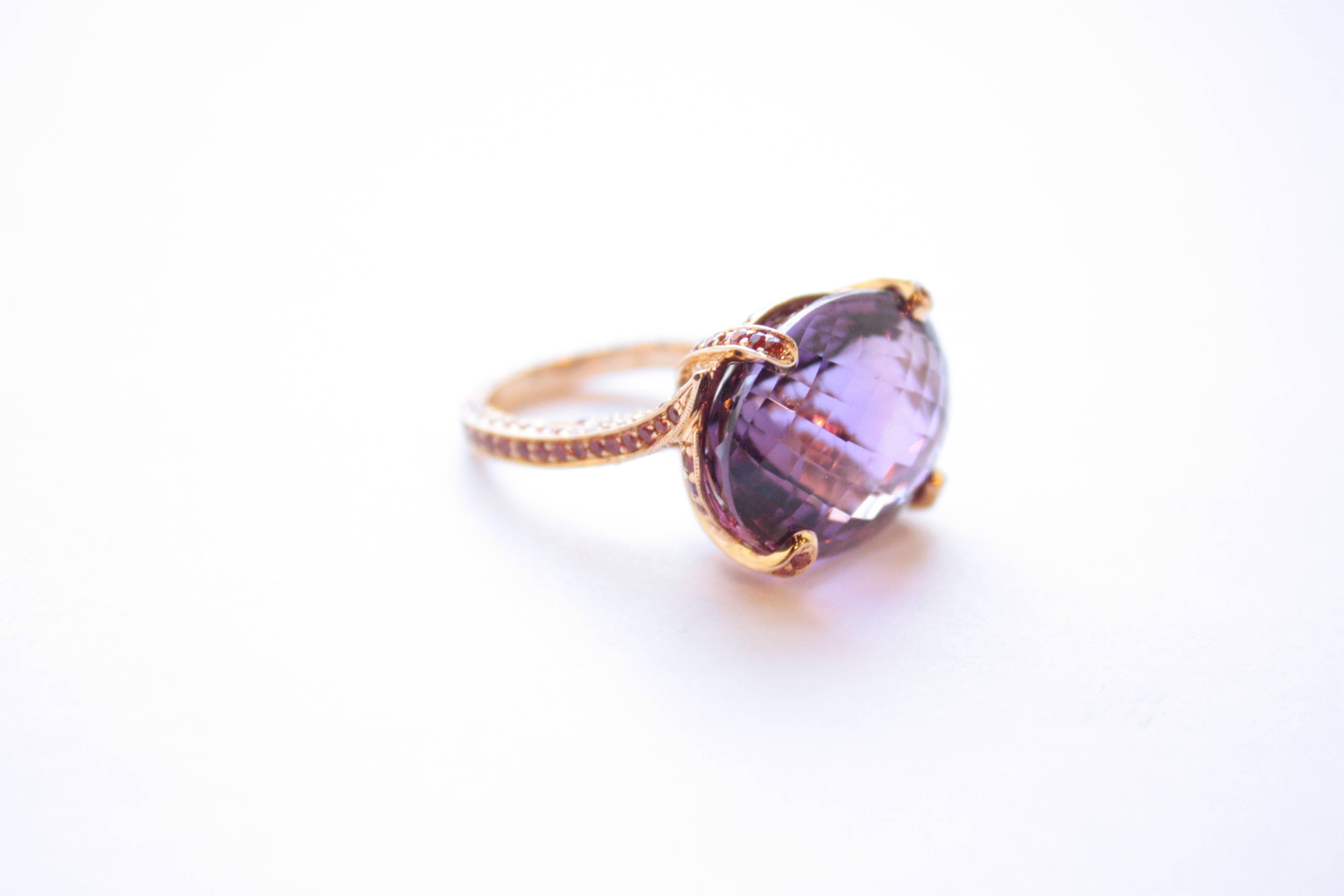 Amethyst & Orange Sapphire Ring
An eighteen-karat yellow gold ring showcasing a 25.10 carat ovular faceted amethyst.  The shank has been completely set, on all three sides, with orange sapphires. 
Size 7 - adjustable upon request
Orange Sapphire