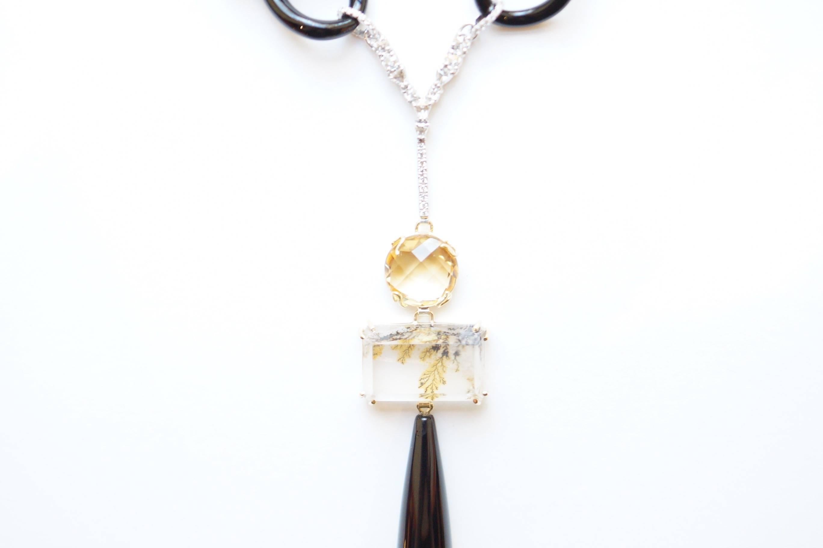 Bumble Necklace
A platinum and eighteen-karat yellow gold necklace, uniting an edgy grouping of black onyx, citrine, dendritic quartz and black quartz.  This necklace begins with a double eighteen-karat white gold chain that loops into links carved