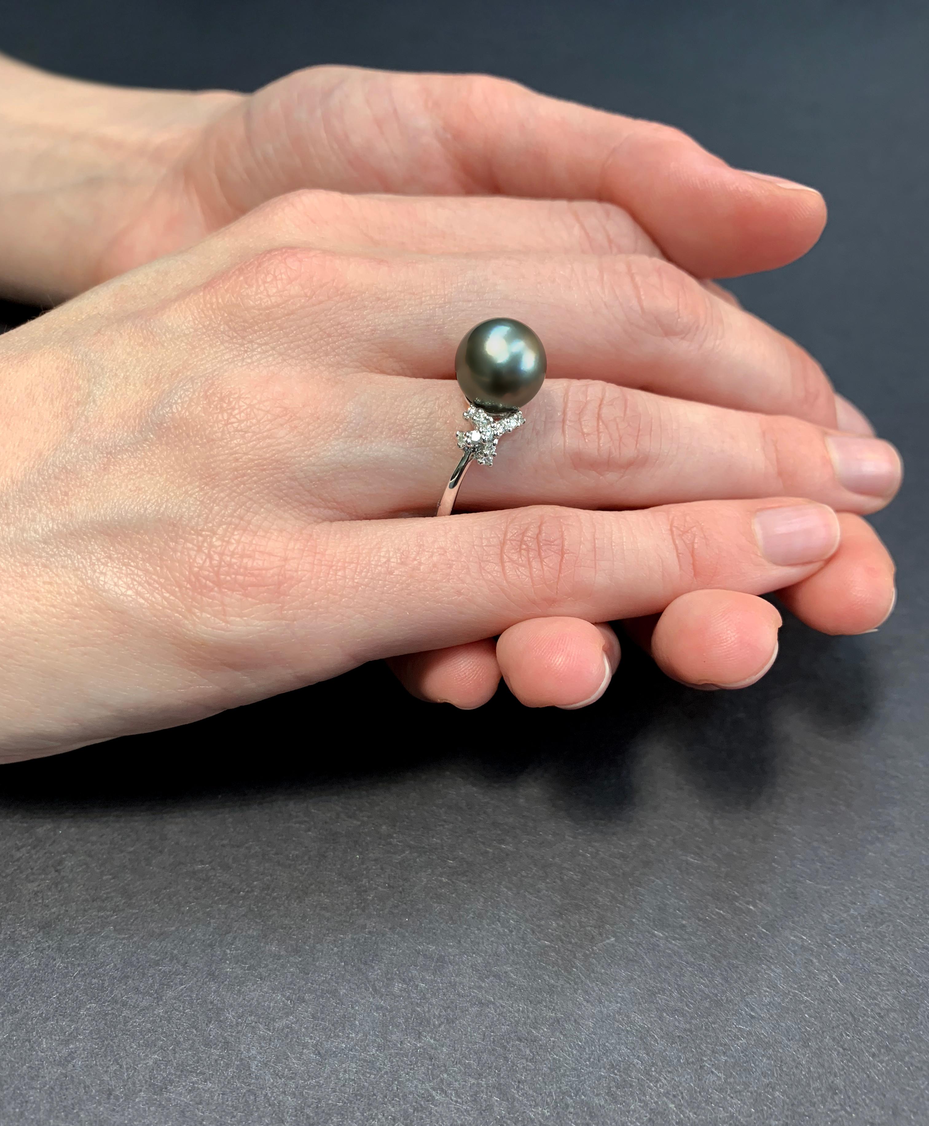 This graceful ring by Yoko London features a lustrous Tahitian pearl set between two diamond ‘kisses’. The 18 Karat white gold setting enriches the cool hues of the Tahitian pearl and the white sparkle of the diamonds. This ring holds romantic