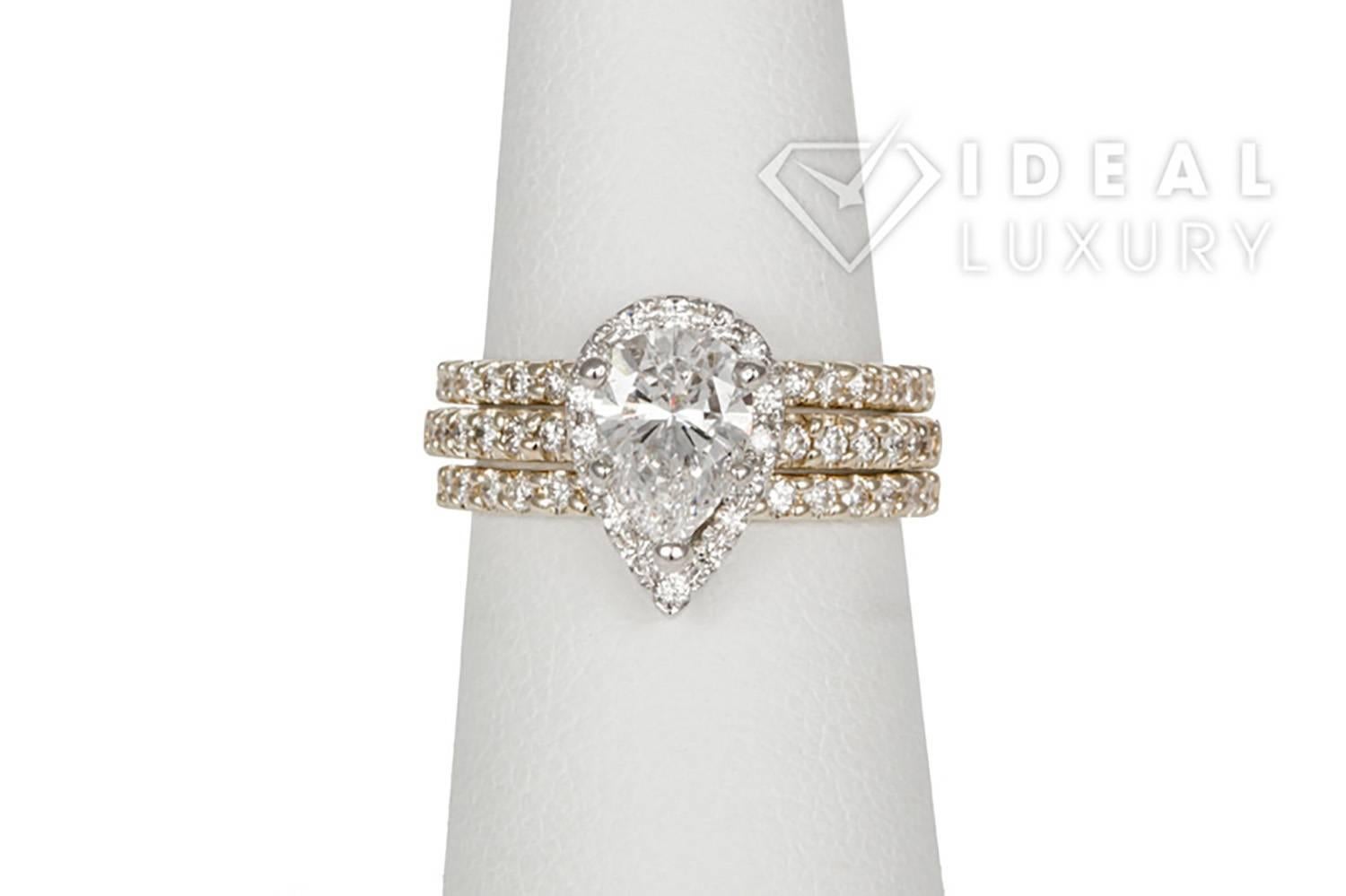 Ideal Luxury is pleased to present this Ladies EGL 14K Two Tone Yellow & White Gold Pear Diamond Halo Engagement Ring & Wedding Band Set. This beautiful wedding set features an EGL Certified 1.05ct D/SI2 Pear Cut Center Diamond accented by an