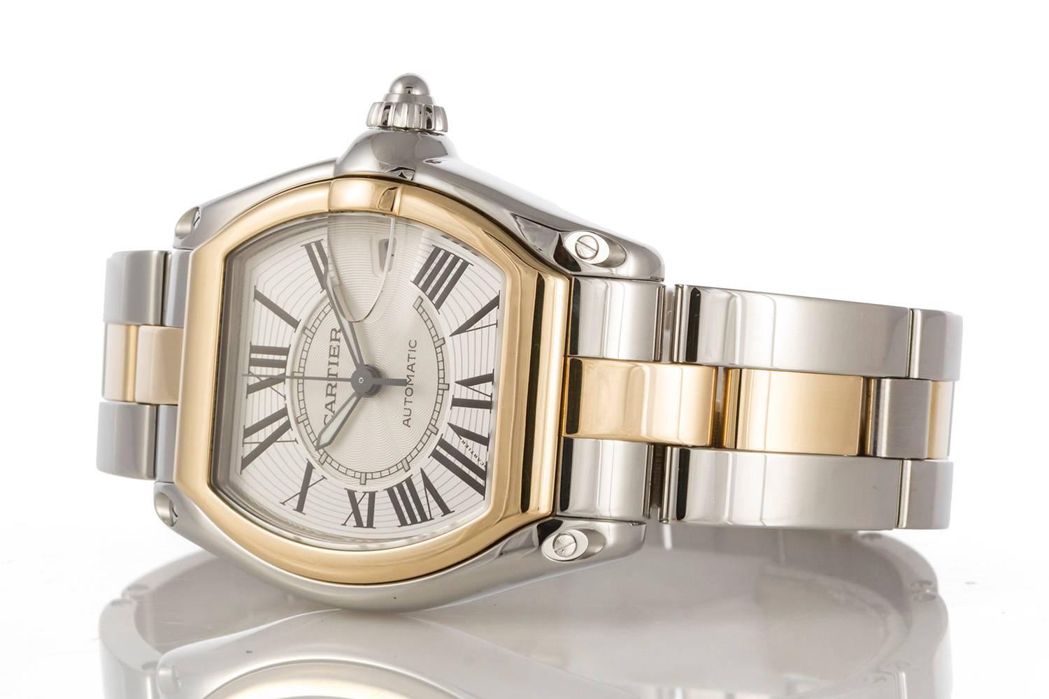 Authentic Cartier 18k Gold & Steel Two Tone Automatic Large Roadster W62031Y4. This watch features a 38mm x 44mm case. The watch comes with an extra Cartier black nylon strap. It is in very good shape with very few signs of wear. This watch has