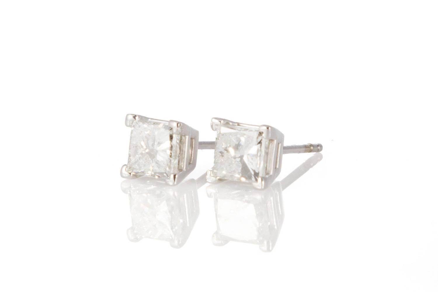 Ladies 14K White Gold & Princess Cut Diamond Stud Earrings. These beautiful earrings feature 1.64ctw G-H/I1 Princess Cut Diamonds set in 14k White Gold studs with slide back setting. The earrings are in very good condition and show very few