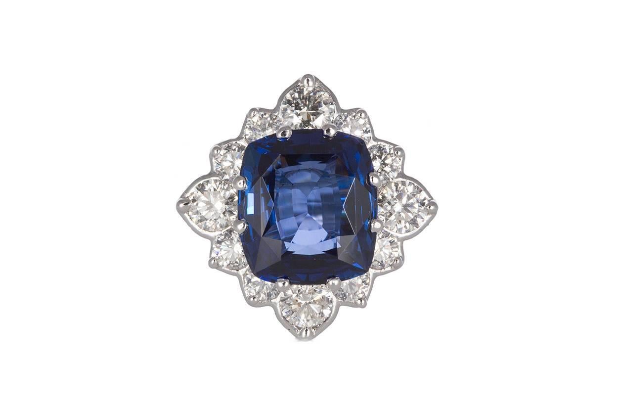 18k White Gold Diamond & Cushion Cut Ceylon Sapphire Cocktail Ring. This ring is fashioned from 18k White Gold and features a stunning 9.05ct cushion cut ceylon sapphire center stone accented by an estimated 2.50ctw F-G/SI Round Brilliant Cut