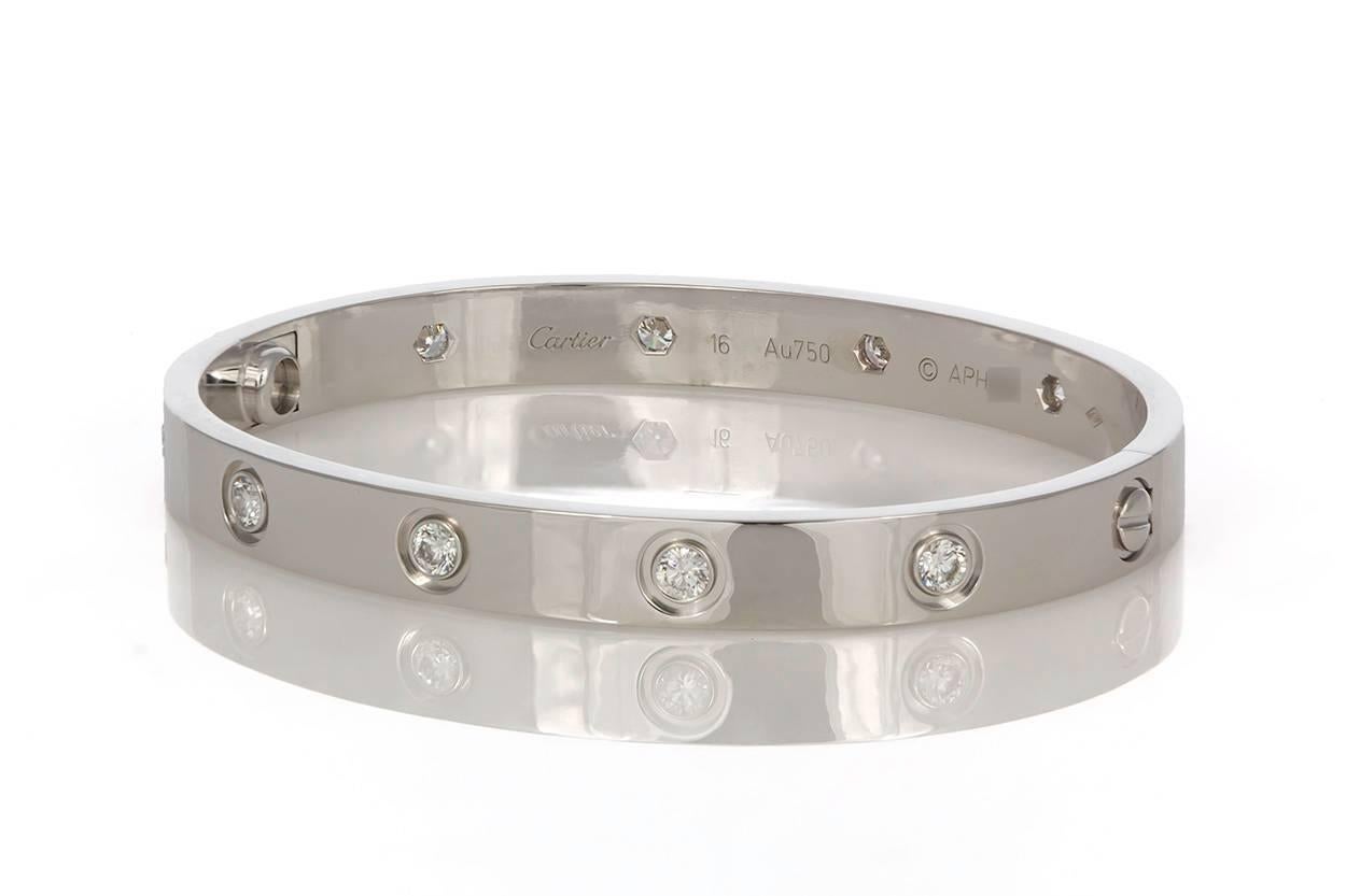 We are pleased to offer this Authentic Cartier 10 Diamond Love Bangle in 18K White Gold with it's original screw driver, Cartier Box and Papers. It features 0.96ctw D-F/VVS Round Brilliant Cut Diamonds set in 18k White Gold. It also features the new