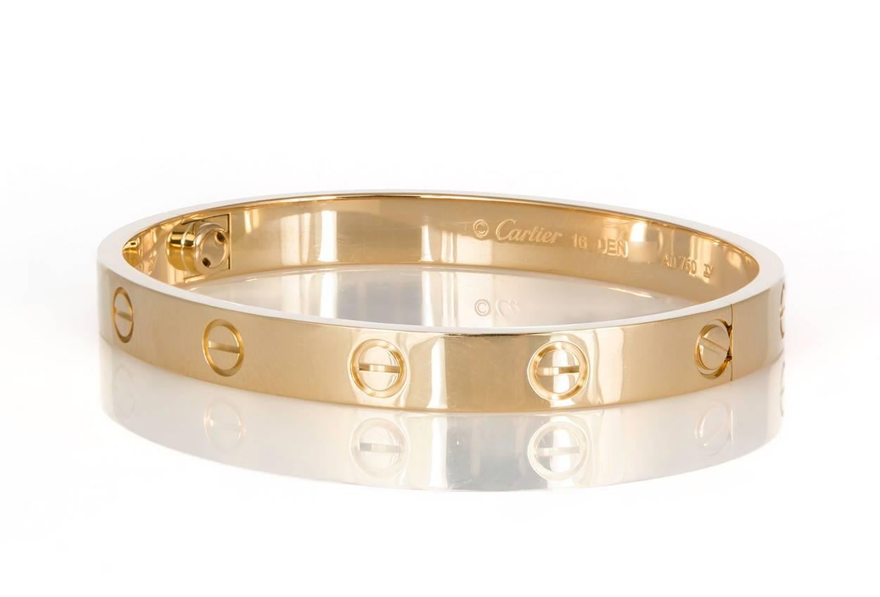 We are pleased to offer this Authentic Cartier Love Bangle in 18K Yellow Gold with it's original screw driver, Cartier Box and Papers. It features the new style screw system which makes it much easier to take on & off. A child of 1970s New York, the