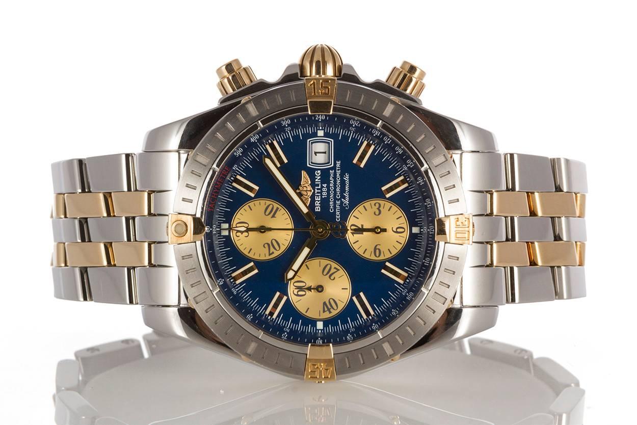 Authentic Breitling Two Tone Chronomat Evolution Automatic Watch B13356. The watch features a two tone solid 18k yellow gold and stainless steel finish with a blue dial and automatic chronograph movement. It has a 44mm case and will fit up to a