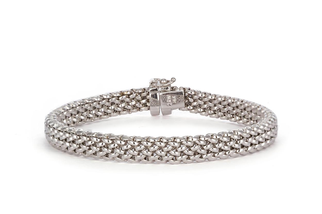 We are pleased to present this Beautiful 14k White Gold Braided Ladies Bracelet. It features a stunning woven or braided design with push style clasp and additional safety clasp. The bracelet will fit up to a 7″ wrist. It is in like new condition
