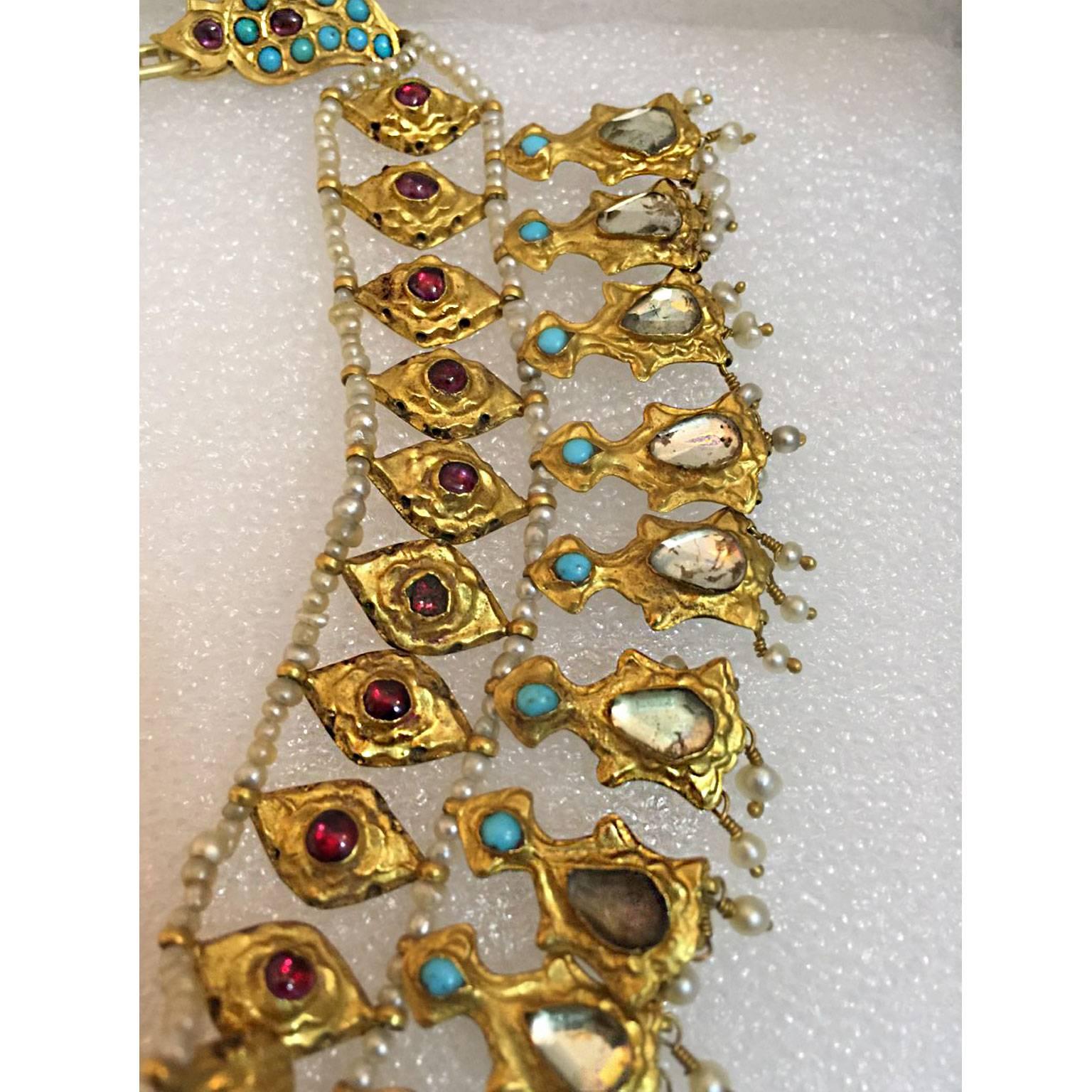 An Antique Rajasthan Mughal necklace made of 22K gold and with a set of ruby, turquoise, pearl and glass. 