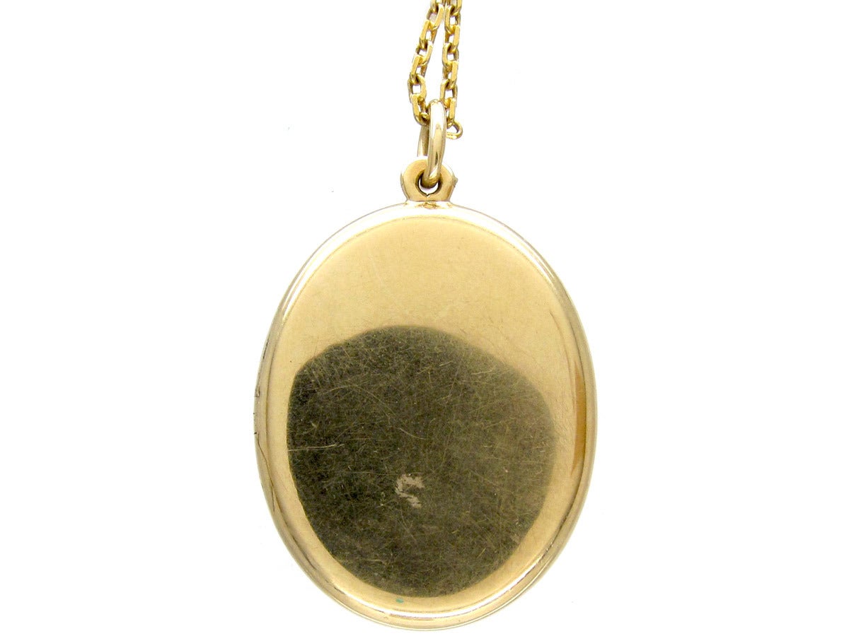 An unusual  14kt locket  which was made in Pre Revolutionary Russia circa 1910. It is a beautiful pale apple green colour  enamel and is set with a diamond.  The gold is engraved like waves underneath the translucent enamel. Inside there are two