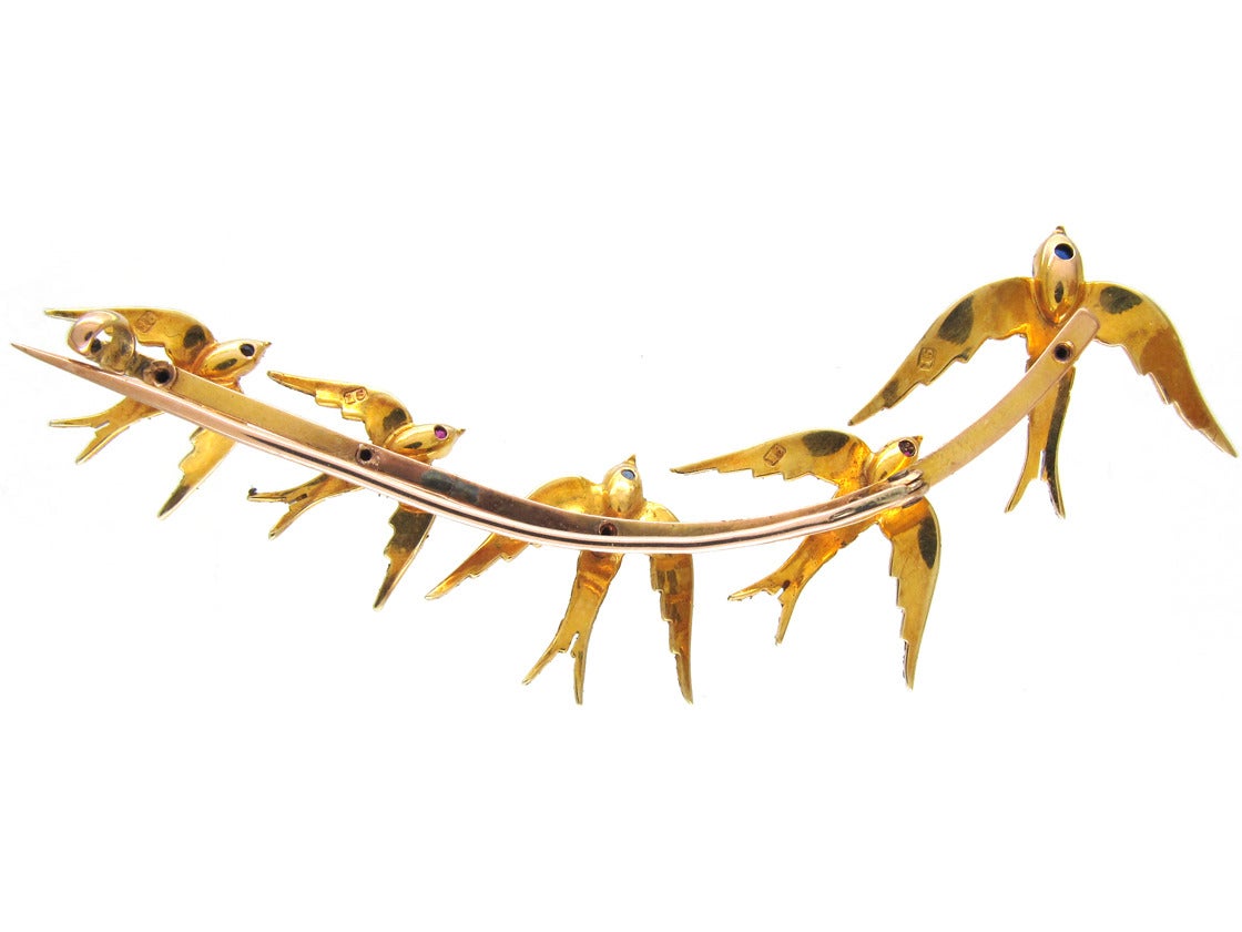 A beautiful large 15ct gold brooch containing five swallows from large to small along the main bar. In Classical Chinese paintings the swallow represented happiness and the arrival of Spring, and was often depicted as part of the flowering peach
