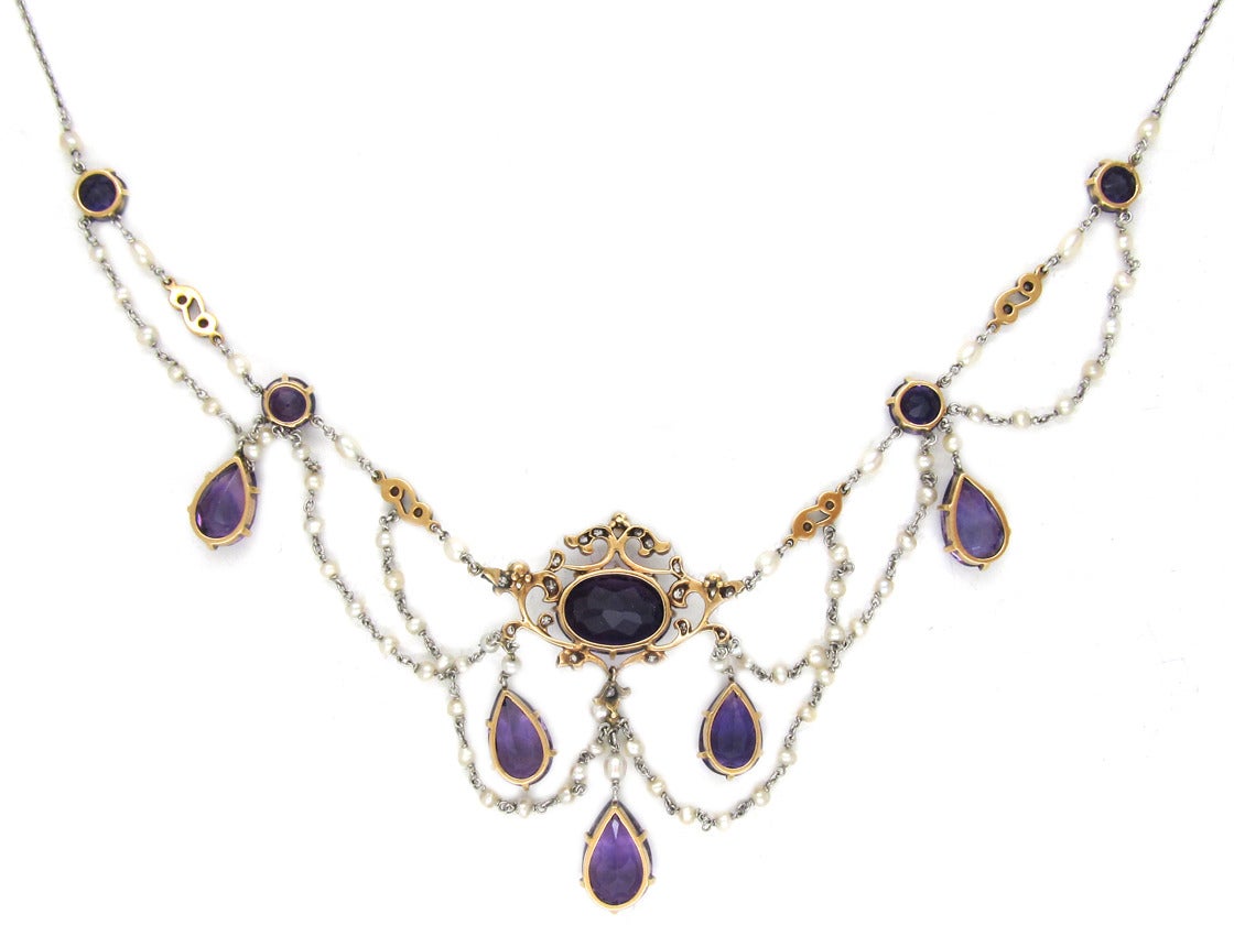 A wonderful amethyst, diamond and natural pearl necklace in its original leather case. It is platinum with 15ct gold mounts on the amethyst sections. It was made at the height of the “Belle Epoque”, circa 1910.