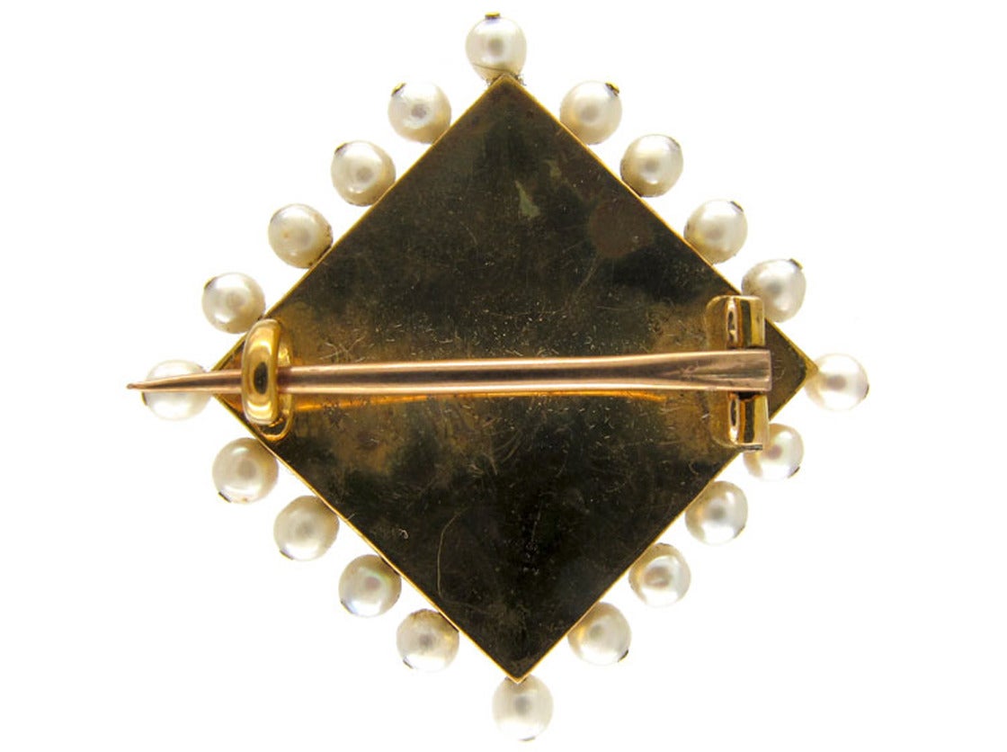 A wonderfully sentimental 15ct gold brooch, surrounded by natural pearls, with a double heart studded with small diamonds. It would have been given as a love token in the Edwardian period, circa 1915. The enamel is a beautiful green and it is in
