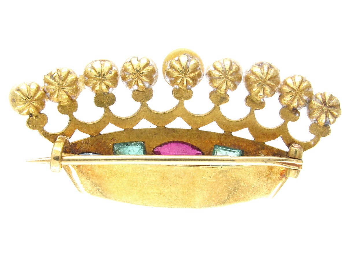 A fantastic 18ct gold, late Victorian crown brooch set with nine natural pearls and emeralds, sapphires and a ruby. It is very well made and unusual.
