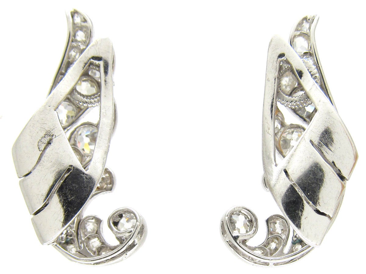 A lovely pair of 18ct white gold Art Deco earrings which have been set with old mine cut diamonds. They are in the form of wings and clip on up the ear. The effect is fabulous.