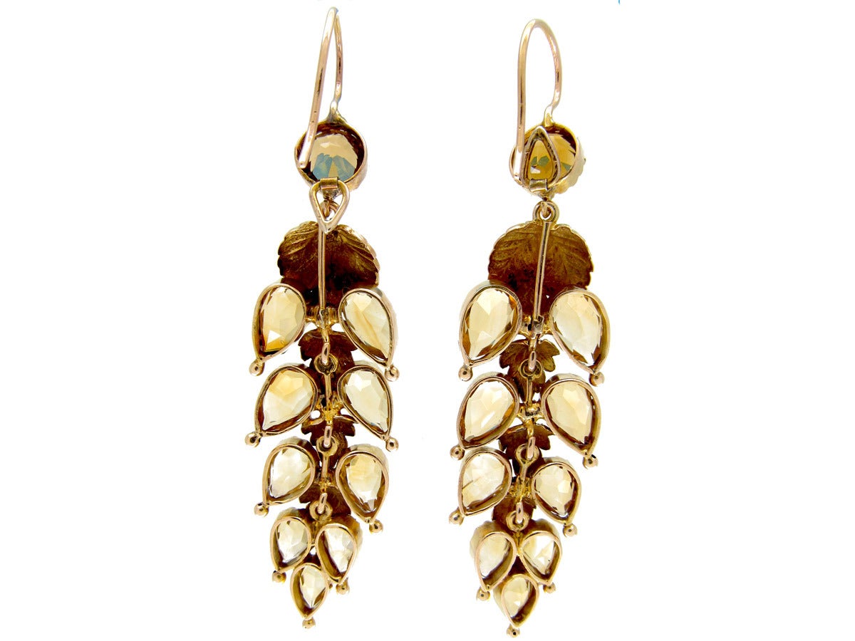 An unusual pair of late Georgian Citrine drop earrings of leaf design set in 15ct gold. Each leaf is articulated so the earrings hang well and move beautifully when worn. It is rare to find Georgian earrings in citrine; garnet was a much more