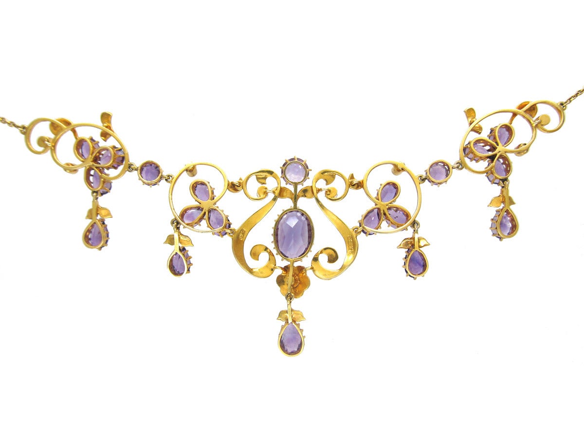 This necklace is in excellent condition. It flows beautifully around the neck and is set with shaped amethysts and natural pearls. It was made circa 1900-1910.