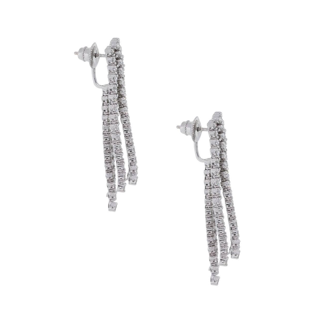 Material: 14k white gold
Diamond Details: Approximately 4.42ctw of round brilliant diamonds. Diamonds are F/G in color and VS in clarity
Earring Measurements: 1.93″ x 0.19″ x 0.33″
Earring Back: Post friction
Total Weight: 15.7g (10dwt)
SKU: