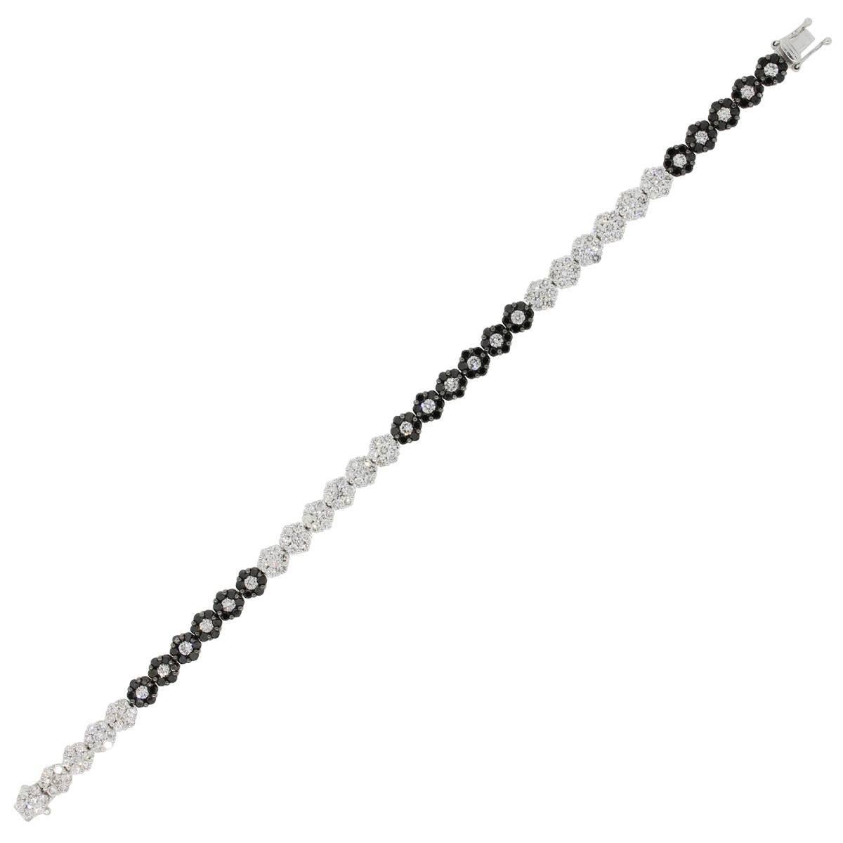 Material: 18k white gold
Diamond Details: Approximately 8ctw of round brilliant diamonds. White diamonds are G/H in color and SI in clarity
Bracelet Measurements: 7″ x 0.14″ x 0.26″
Clasp: Tongue in box clasp with double safety latch
Total Weight: