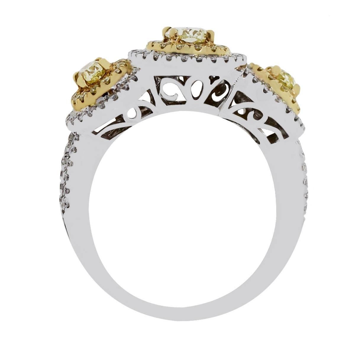 Oval Cut Fancy Yellow and White Diamond Three-Stone Halo Ring
