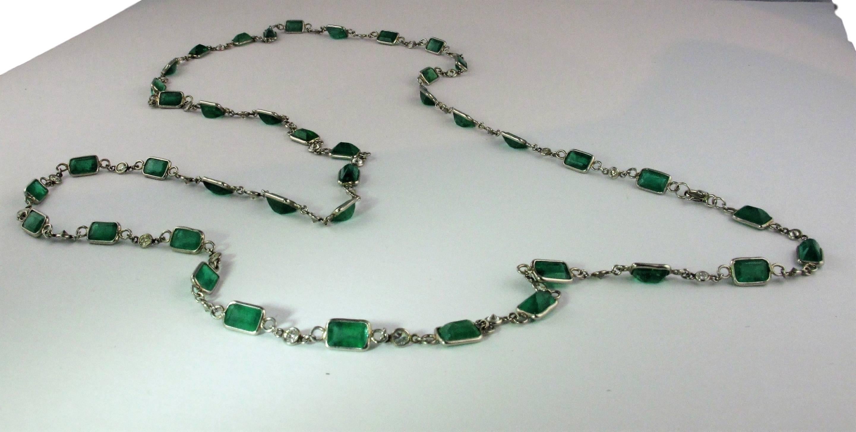 41 Emerald-cut emeralds in platinum setting, each link alternating with a round brilliant-cut diamond. 
Estimatedl weight of 41 Emeralds: 19.45 to 21.5 cts. Est weight of 41 round brilliant-cut diamonds: 4.51 cts.
Long chain necklace or 4 row