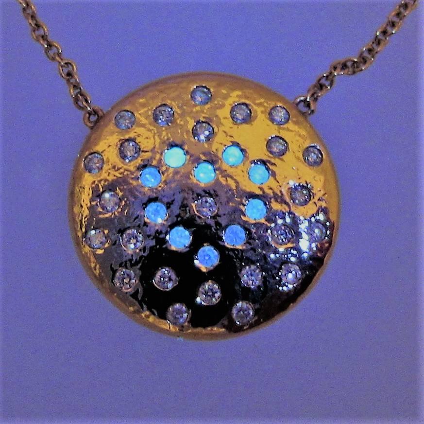 Series 'Les Lumineuses':  PLANET LOVE. Ltd Ed. 10 / 40.
Diamond white scintillations on yellow gold planet. 
PLANET LOVE.   Under gem light natural luminous diamonds glow as blue stars to reveal Bellessort' s iconic LOVE constellation. 
The Diamond