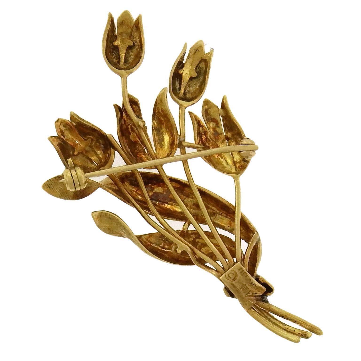 It is always spring when you are wearing Tiffany & Co 18K gold tulip brooch, the parrot tulips delineated in low relief, with the swirling etched leaves wrapping the bouquet. The brooch measures 1