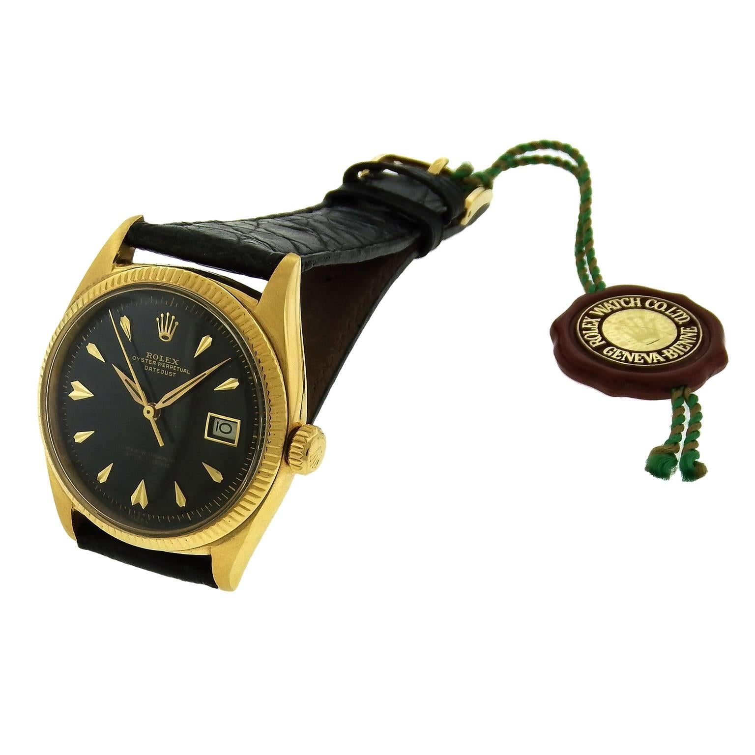 18K yellow gold Rolex Ref. 6605 Oyster Perpetual Datejust, circa 1950's, is a tonneau-shaped, center seconds, self-winding, water-resistant, 18K yellow gold wristwatch with date.  The 36mm case has a screwed-down case back and crown, fluted bezel,