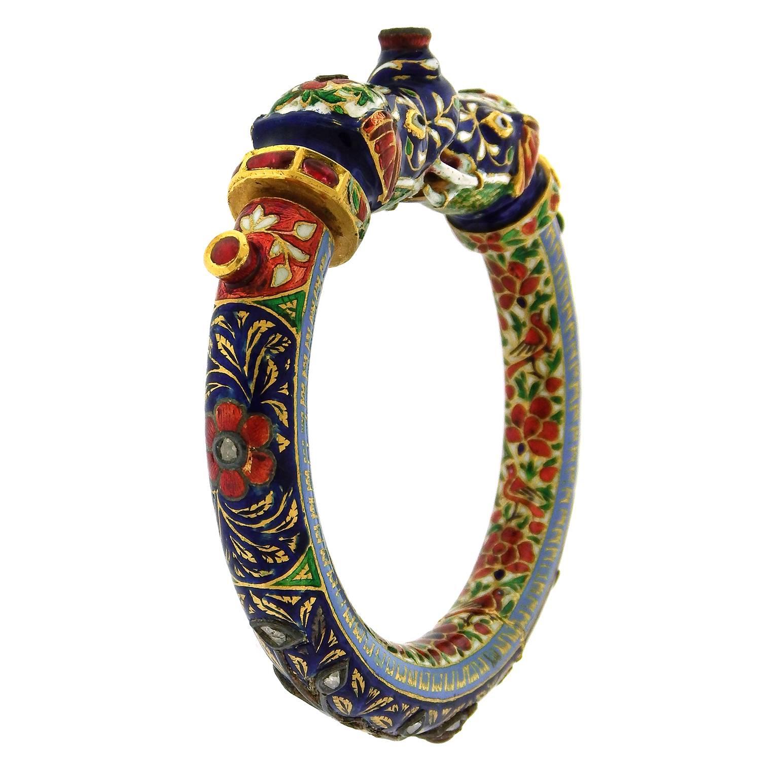 22K gold Mughal elephant bracelet is heavily enamelled and set with rose cut diamonds and ruby  as well as enamel.  The 10mm round enamel bracelet opens at either side with gem-set gold screws that allow the top to slide open.  Made for a small