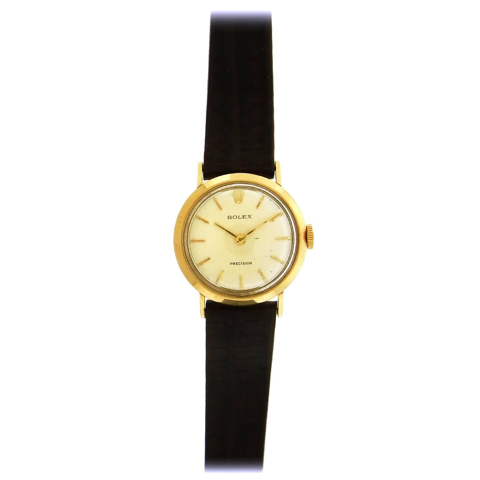 18K yellow gold women's Rolex Precision, circa 1960,  manual wind wristwatch, 23mm diameter, features a silvered dial with applied gold hour indexes, gold baton hands.  The mechanical manual wind movement is warrantied by Aaron Faber for 1 year.