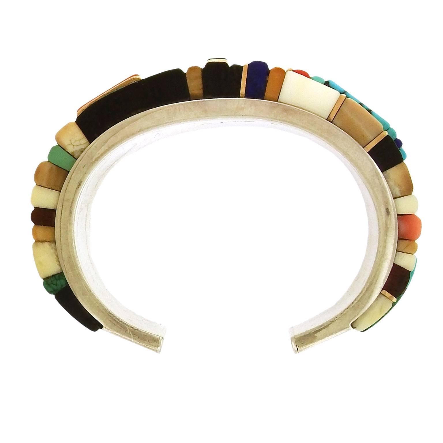 Verma Nequatewa, niece of Charles Loloma, creates one-of-a-kind gemstone jewels in the Hopi tradition under the name Sonwai. This sterling silver bracelet is channel-set  with hand-cut rectangular cabochons, including lapis lazuli, turquoise, coral,