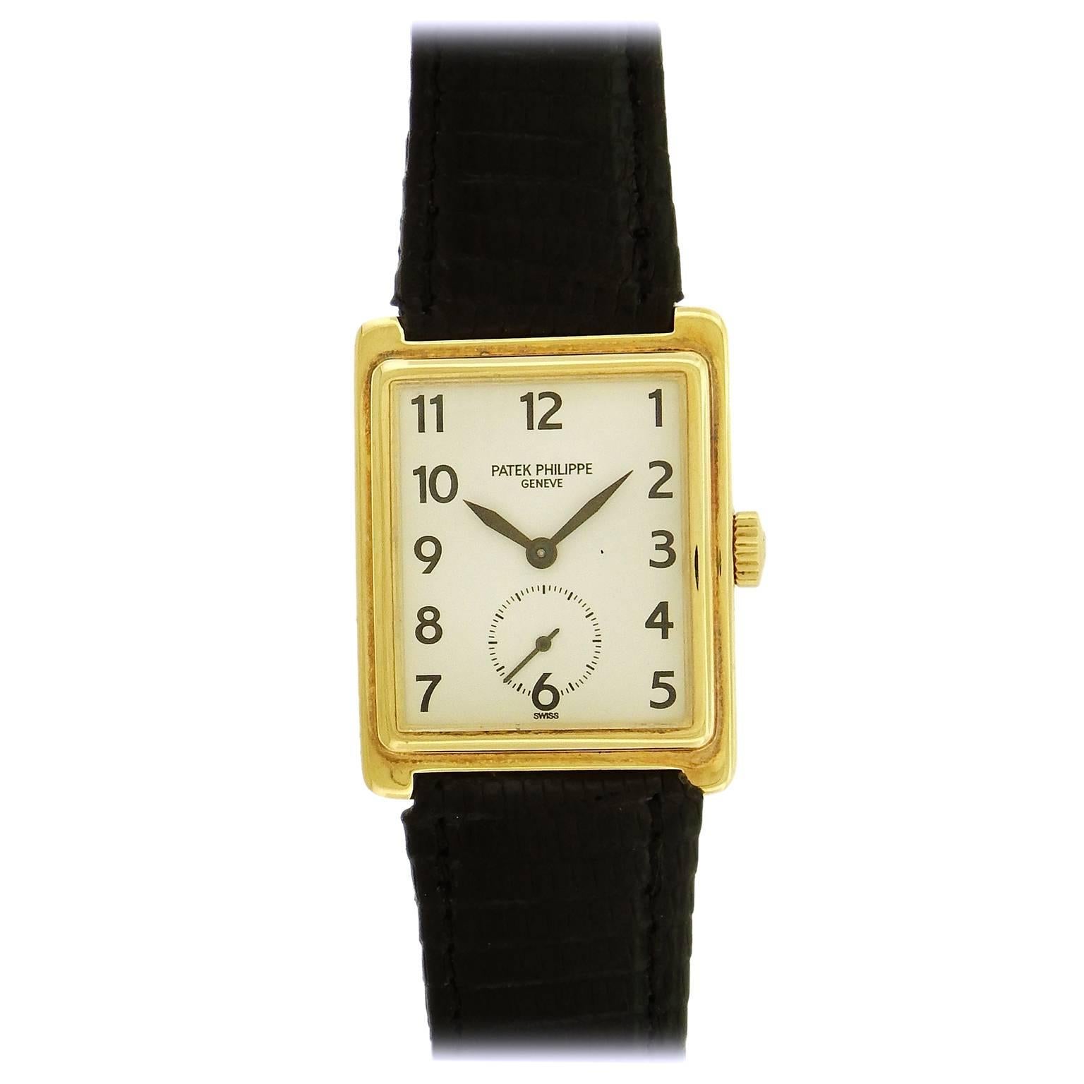 Patek Philippe Ref. 5010 Gondolo in 18K yellow gold is a 28mm x 30mm rectangular dress watch, 18K gold stepped case with a white dial with black painted Arabic numerals, black leaf hands, and subsidiary seconds register.  Manual wind 215 caliber