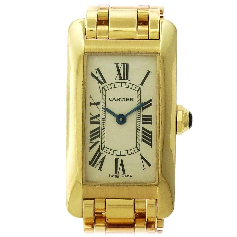 18K yellow gold  women's Cartier Tank Americaine, Ref. 2482, is a women's quartz wristwatch with Cartier bracelet with double fold hidden clasp.  The bombé 19mm x 35mm tank has a matte-finish screw-down back with four screws, matte case band with