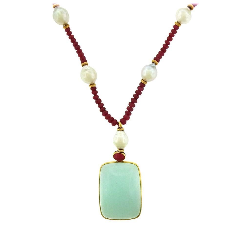 From a private estate, a large sea-green cabochon chalcedony pendant, set in 18K gold, measures 1-1/4