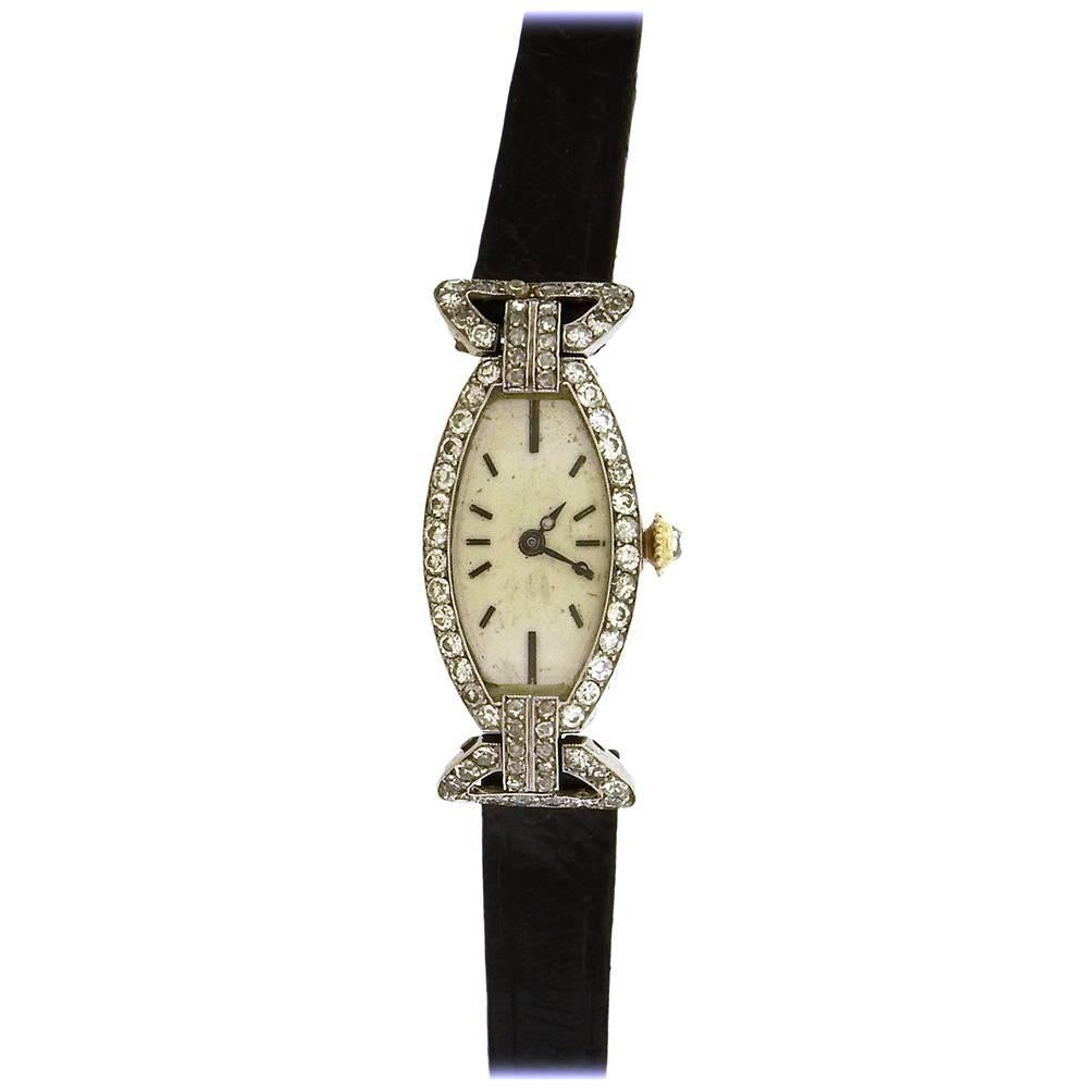 Art Deco platinum and diamond rare Cartier,No. 11476/20148, the movement by European Watch & Clock Co., Inc, made circa 1915. Very fine and very rare, Art Deco, tonneau-shaped, platinum and rose-cut diamond-set women's wristwatch, 15mm x 36.5mm,