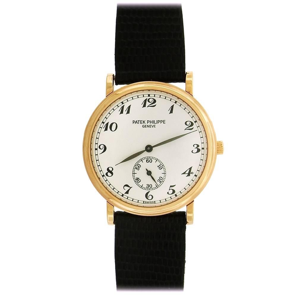 The Patek Philippe Ref. 5022R Officer's Calatrava, circa 2000, is an elegant manual wind dress watch in 18K pink gold with Patek rose gold deployant buckle and stepped polished double bezel, white porcelainized dial with printed Arabic numerals and