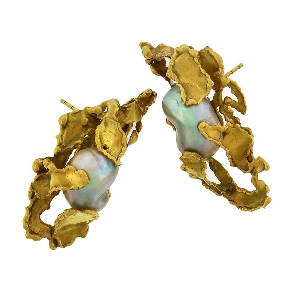 Rare 18K gold and baroque pearl earrings by Irena Brynner (1917-2003) are made in her signature water-torch fabrication technique, the iridescent 'peacock' pearls measuring 17mm x 11mm, the earrings measure 3/4